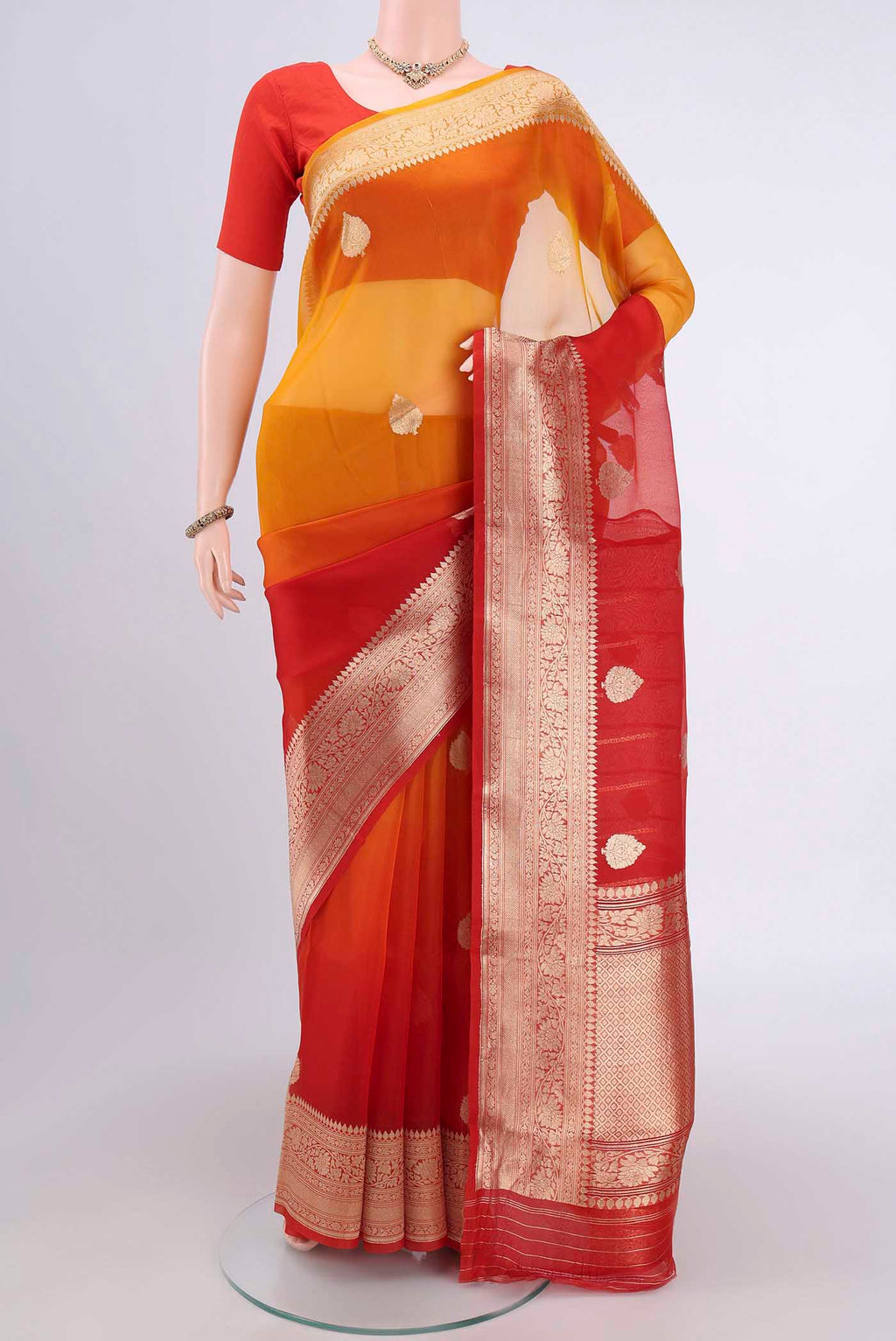 Rust Organza Silk Saree with Half And Half on the body and Zari Border.  displayed on a mannequin