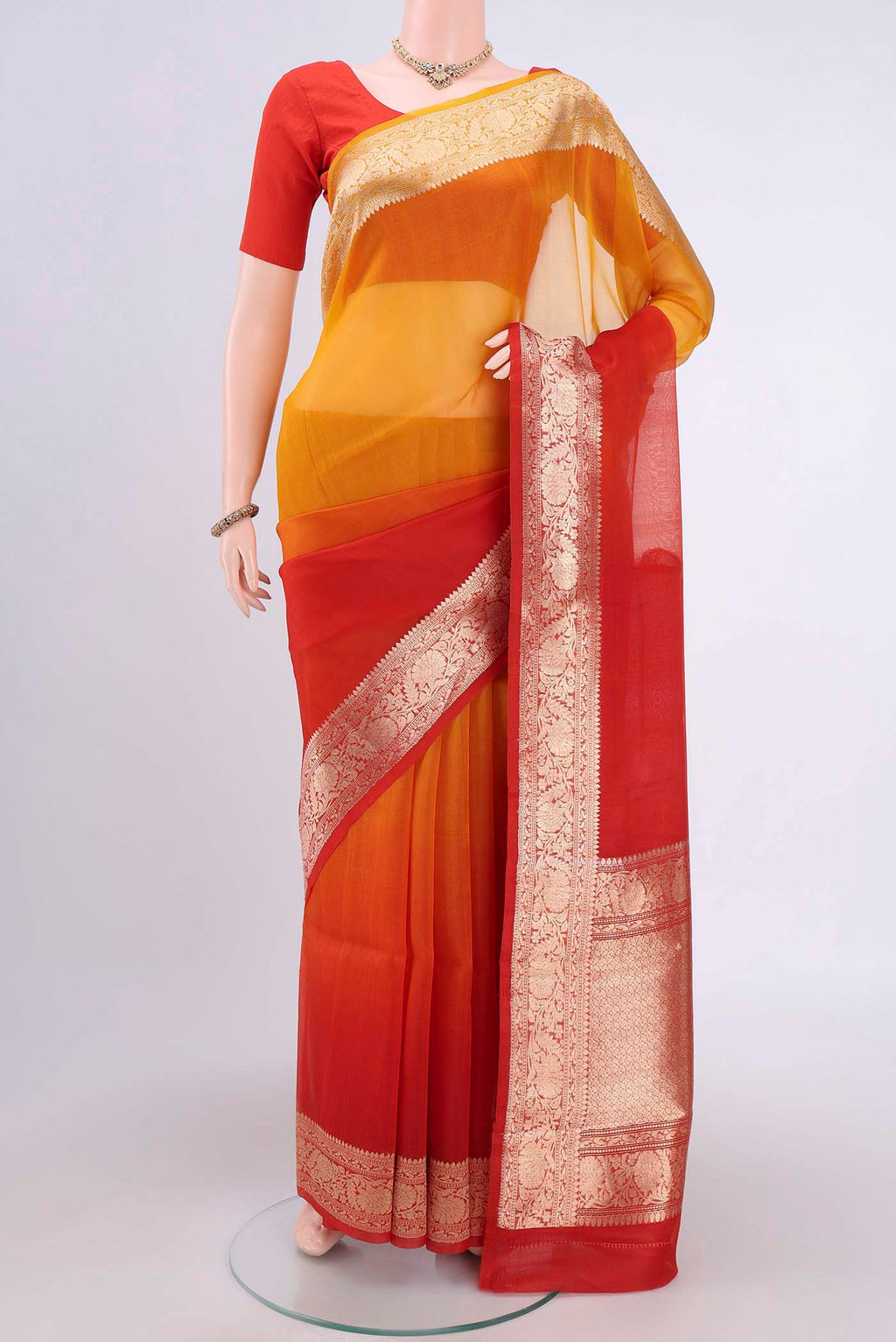 Rust Organza Silk Saree with Half And Half on the body and Zari Border.  displayed on a mannequin