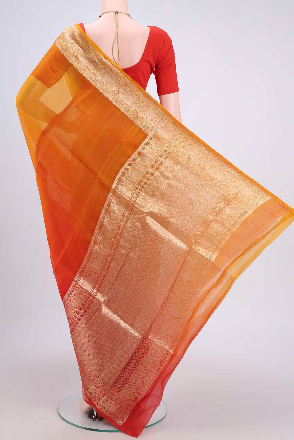 Flat view of Rust Organza Silk Saree with Half And Half on the body and Zari Border. 