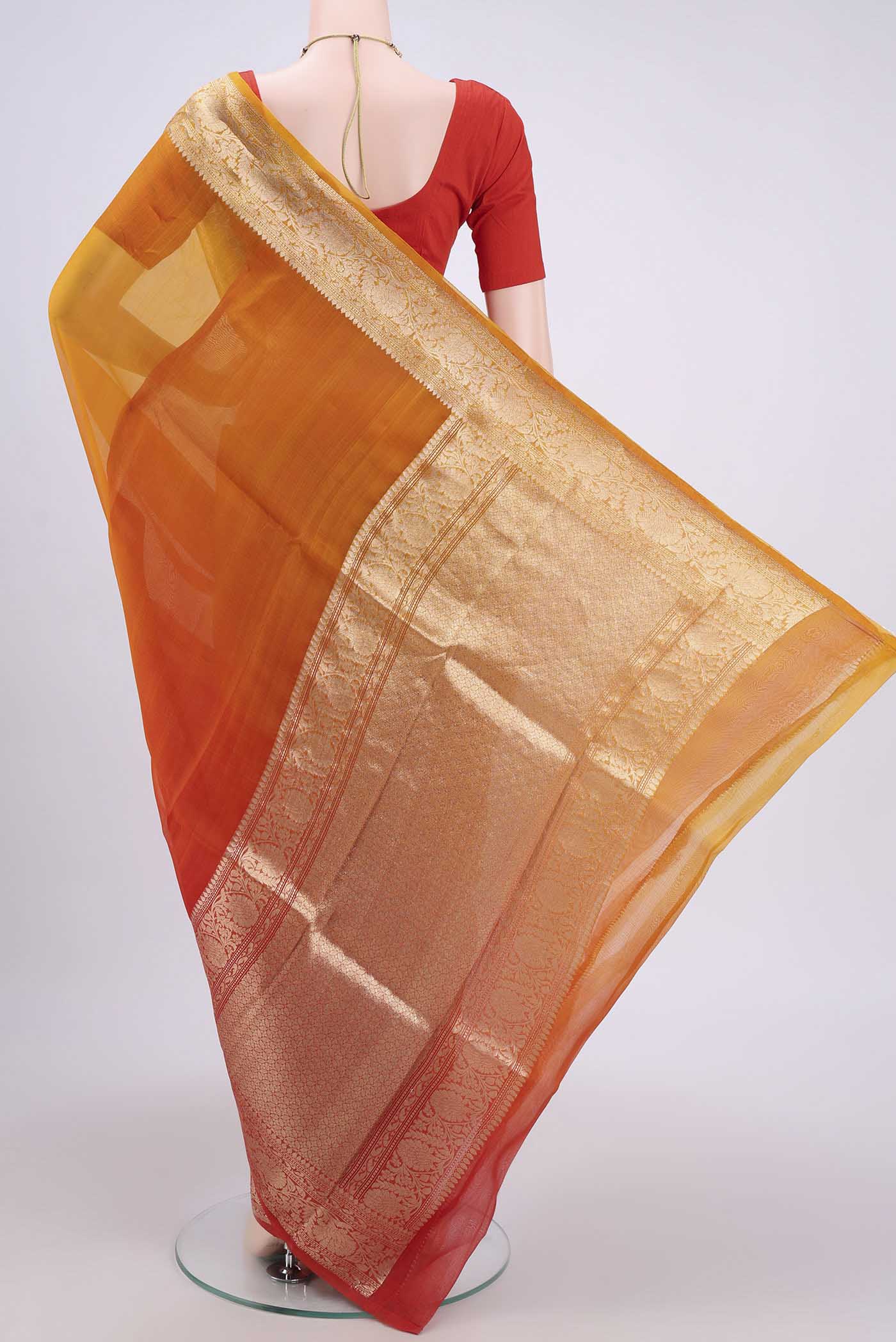 Flat view of Rust Organza Silk Saree with Half And Half on the body and Zari Border. 