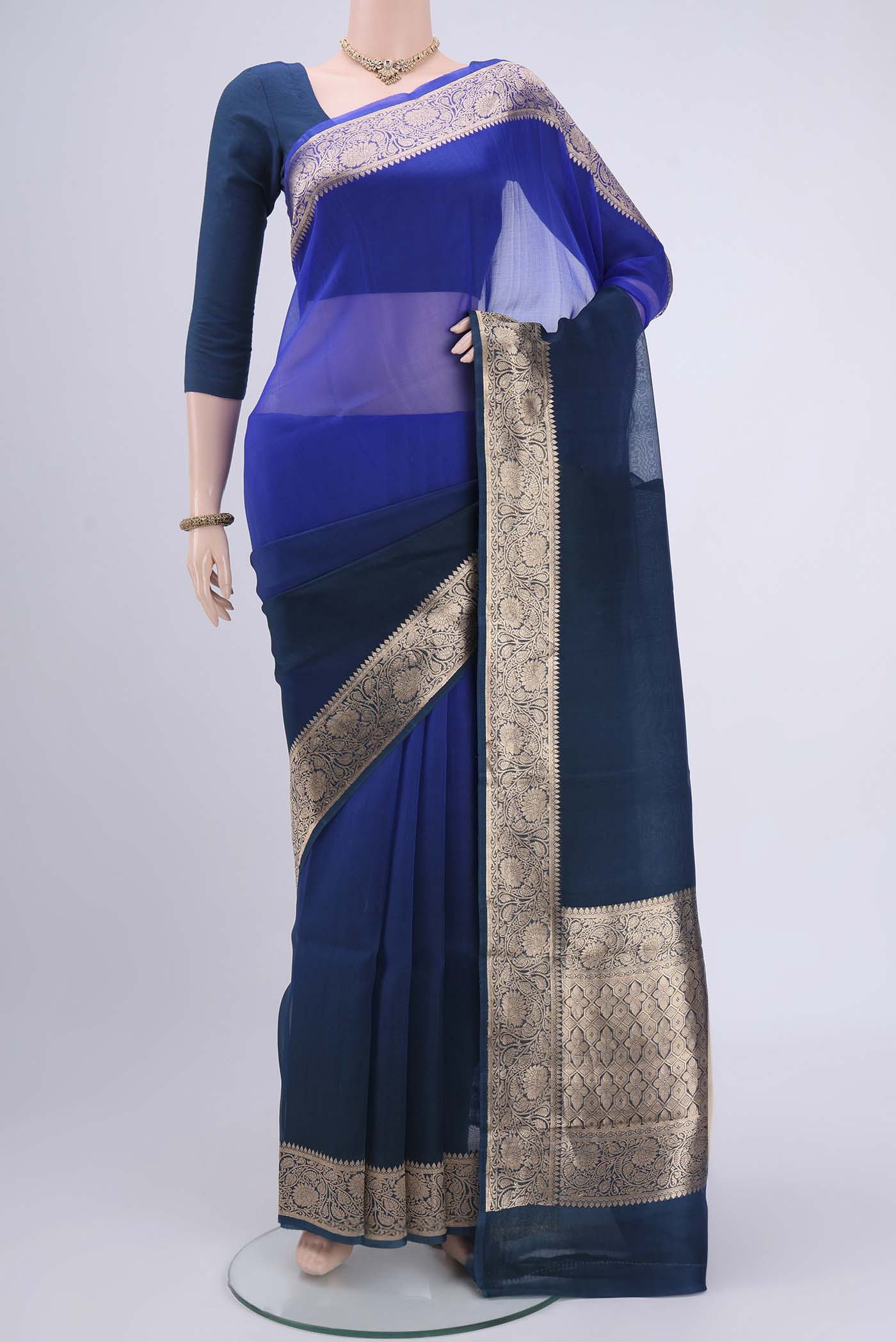 Royal Blue Organza Silk Saree with Plain Body and Zari Border.  displayed on a mannequin