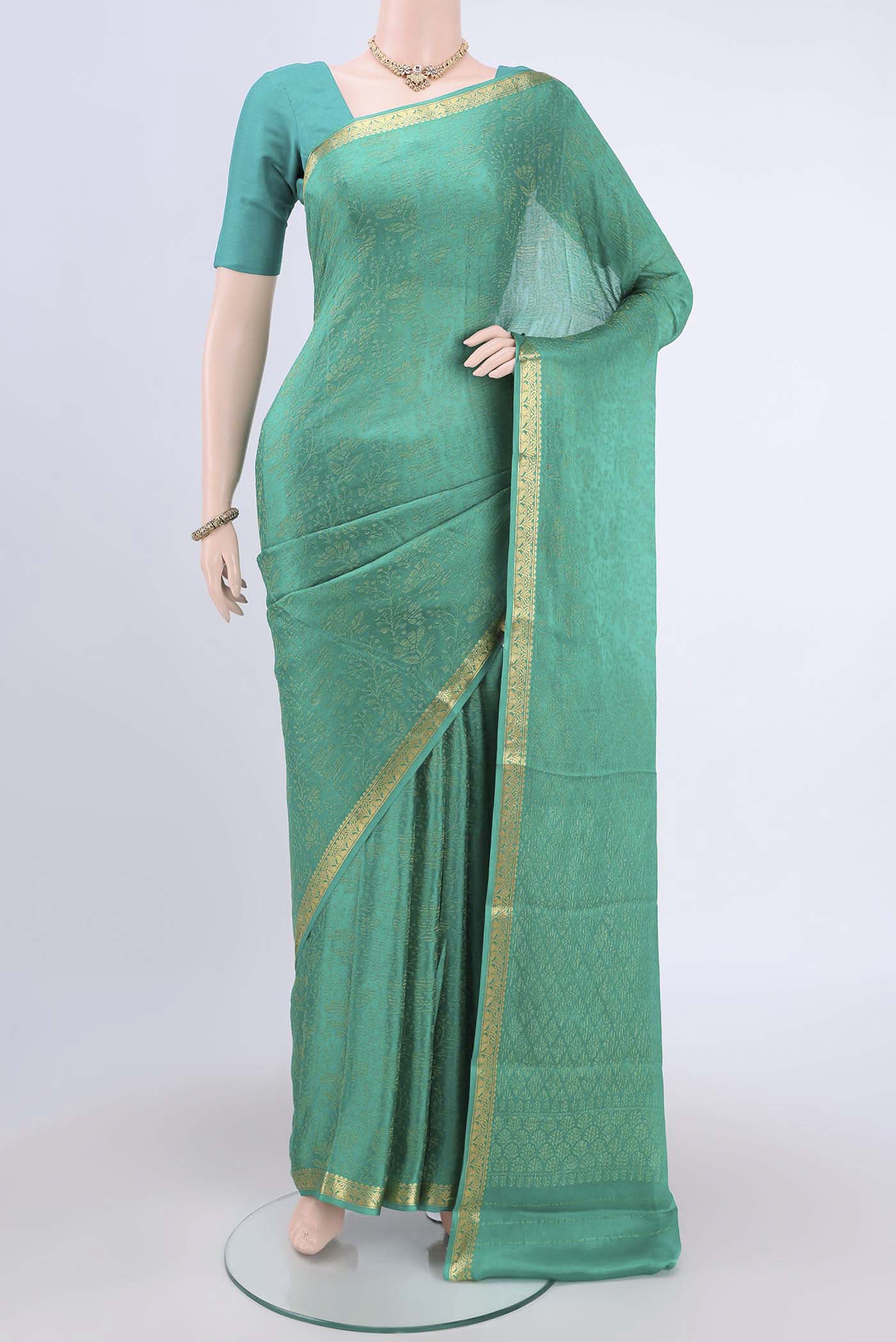 Sea Green Mysore Crepe Saree with Zari Brocade on the body and Zari Border.  displayed on a mannequin
