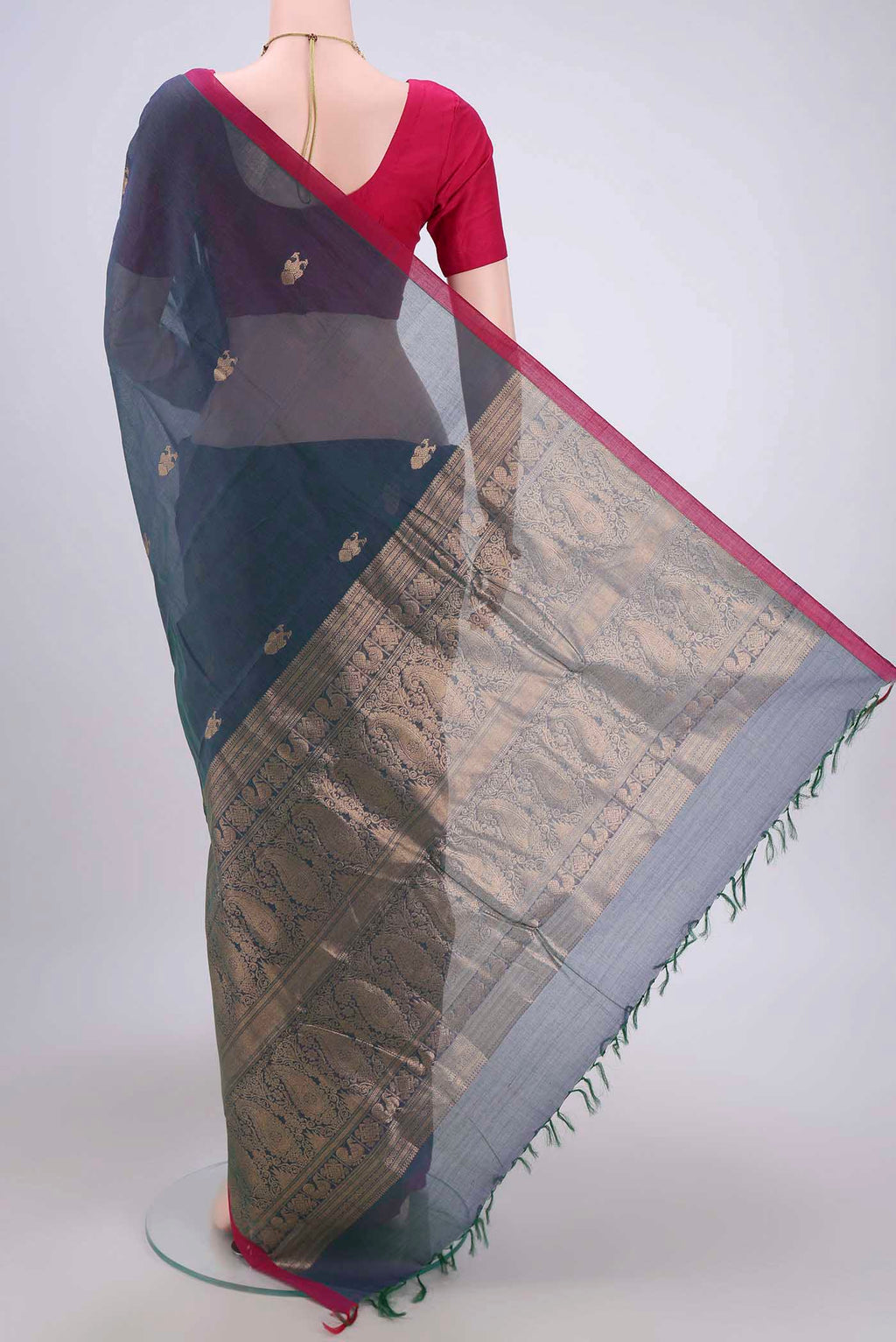 Flat view of Bottle Green Kanchi Cotton Saree with Zari Butta on the body and Zari Border. 