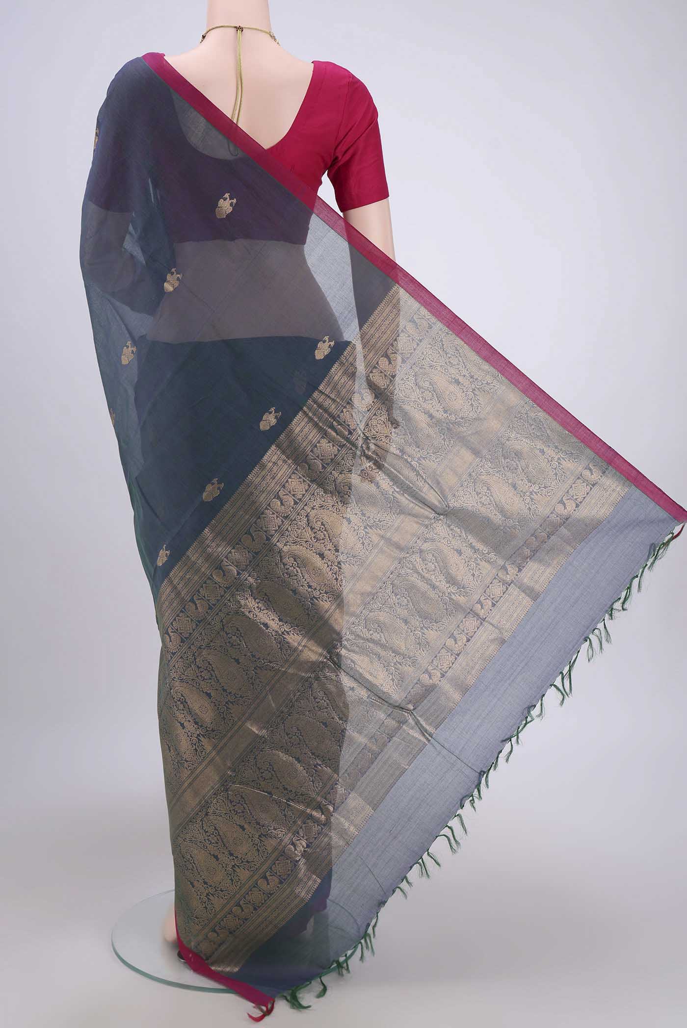 Flat view of Bottle Green Kanchi Cotton Saree with Zari Butta on the body and Zari Border. 