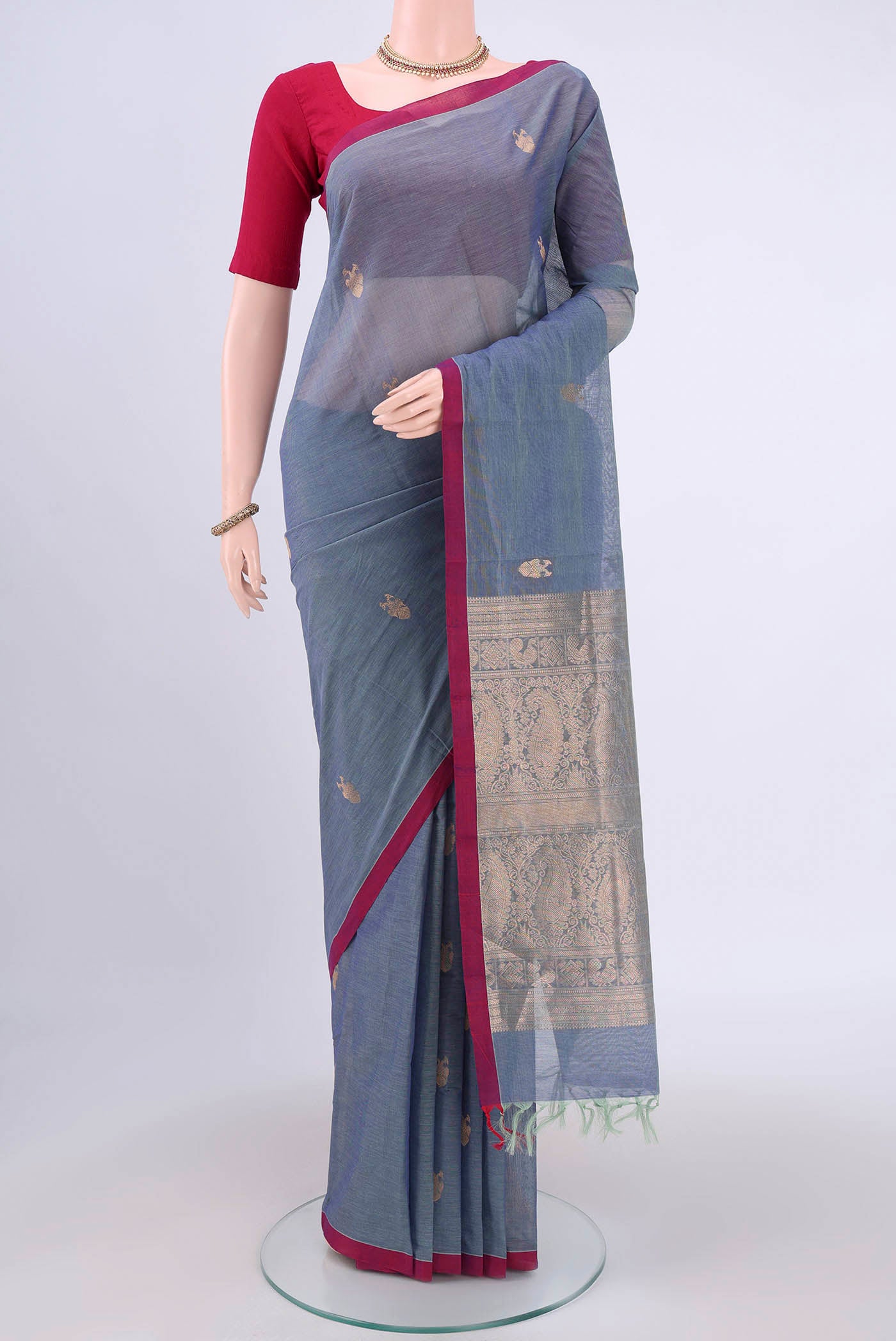 Sky Blue Kanchi Cotton Saree with Zari Butta on the body and Zari Border.  displayed on a mannequin