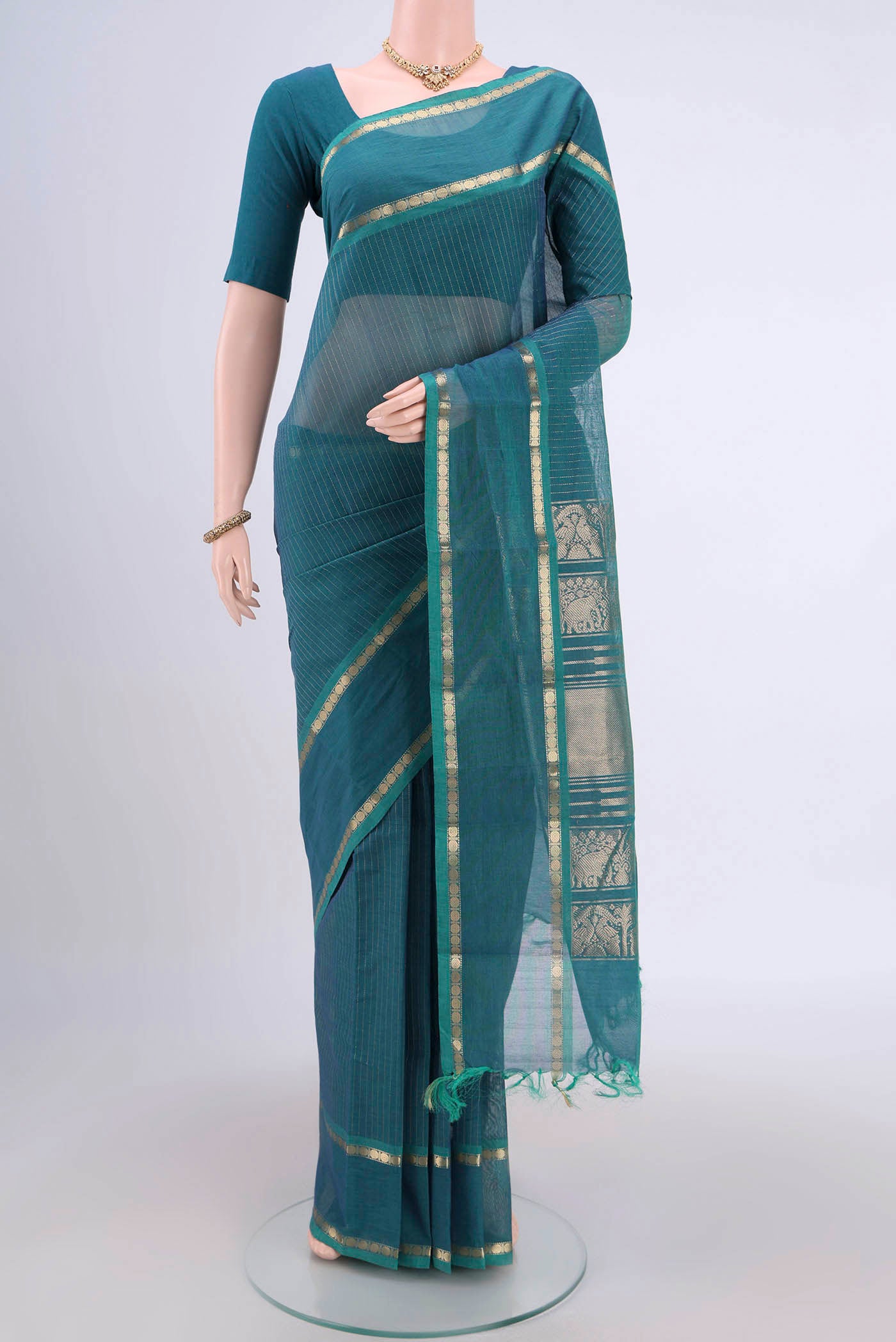Sea Green Kanchi Cotton Saree with Stripes on the body and Zari Border.  displayed on a mannequin