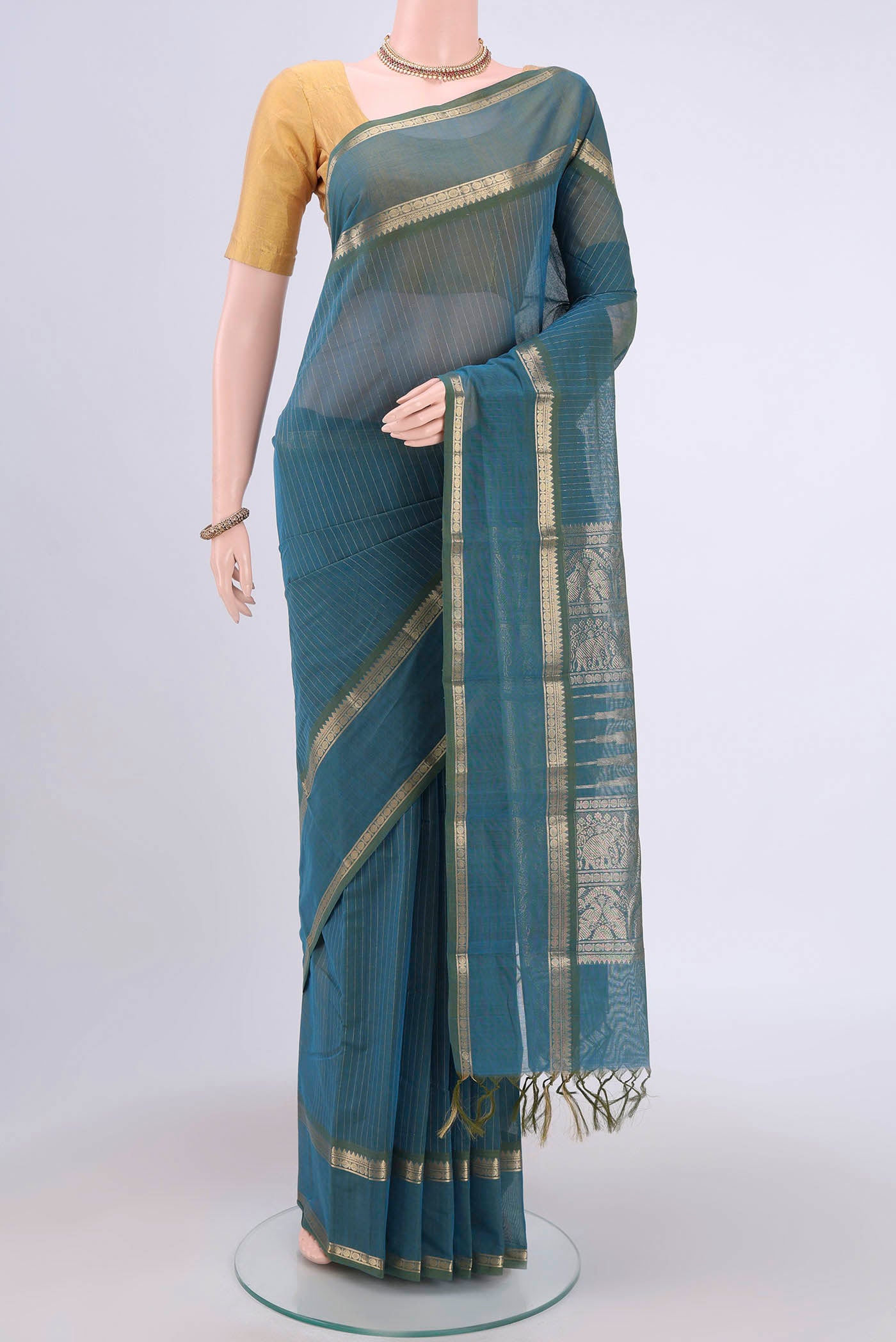 Green Kanchi Cotton Saree with Stripes on the body and Zari Border.  displayed on a mannequin
