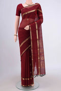 Maroon Kanchi Cotton Saree with Plain Body and Zari Border.  displayed on a mannequin