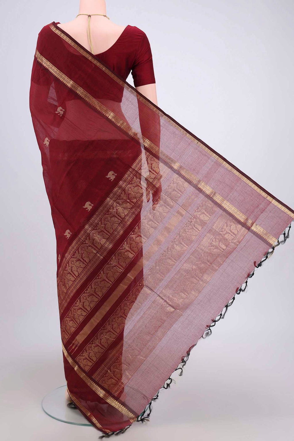 Flat view of Maroon Kanchi Cotton Saree with Plain Body and Zari Border. 
