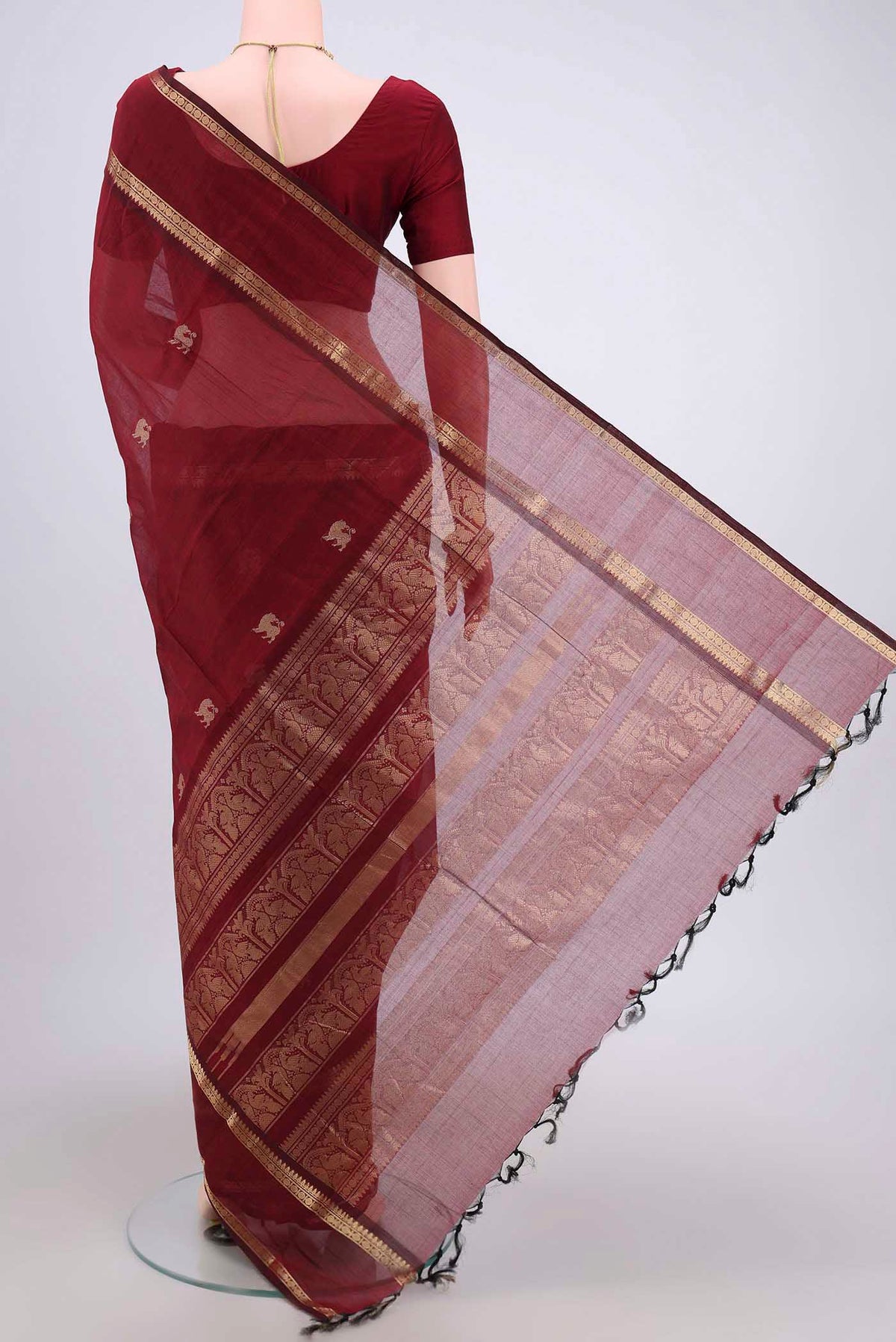 Flat view of Maroon Kanchi Cotton Saree with Plain Body and Zari Border. 