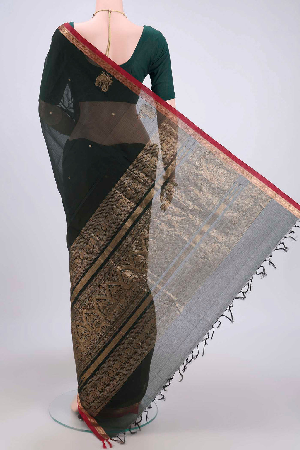 Flat view of Bottle Green Kanchi Cotton Saree with Zari Butta on the body and Zari Border. 