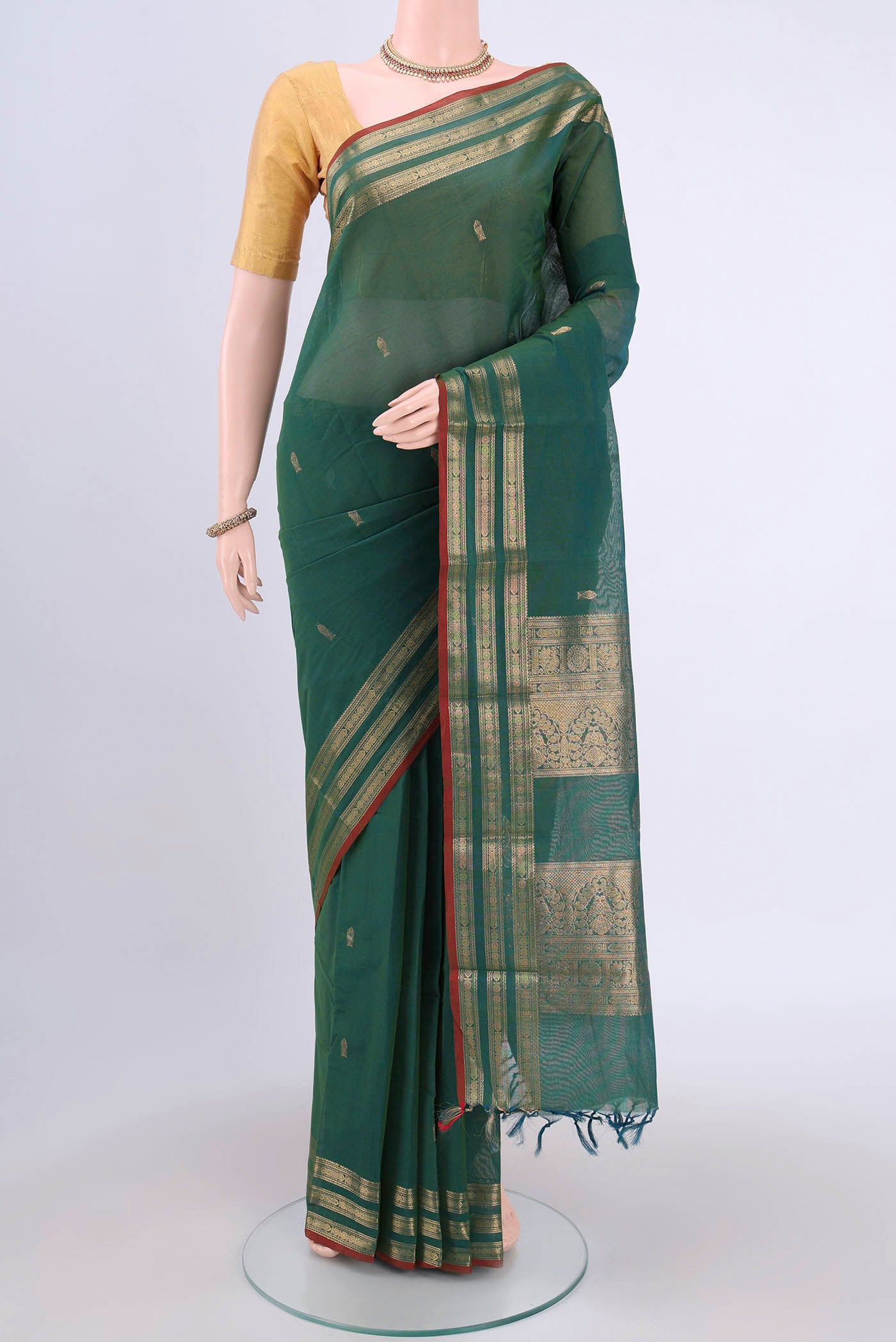 Green Kanchi Cotton Saree with Zari Butta on the body and Zari Border.  displayed on a mannequin