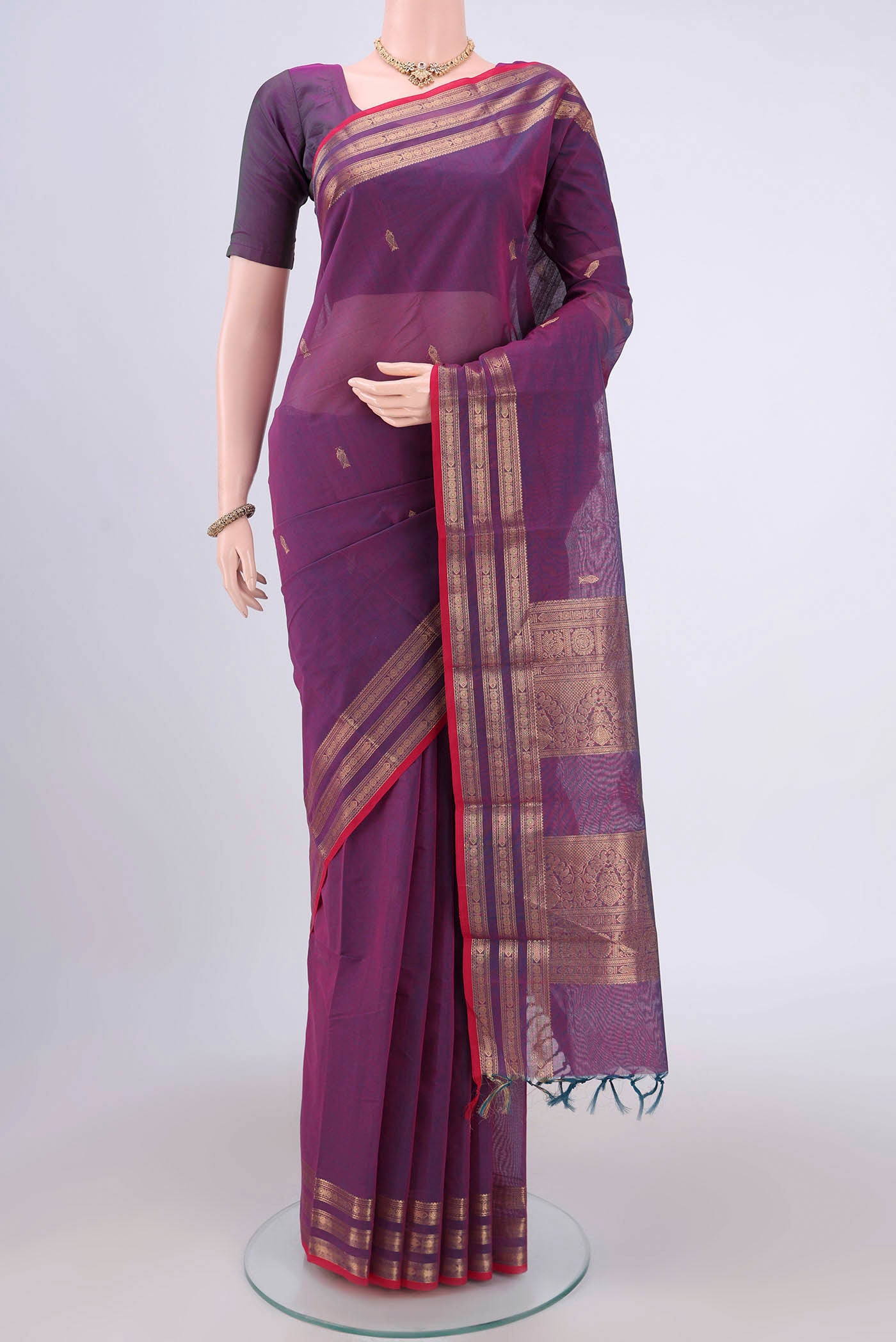 Mauve Kanchi Cotton Saree with Zari Butta on the body and Zari Border.  displayed on a mannequin