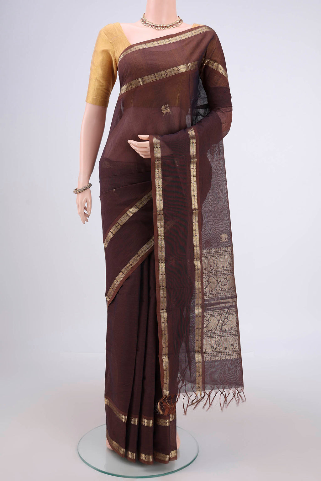 Brown Kanchi Cotton Saree with Plain Body and Zari Border.  displayed on a mannequin