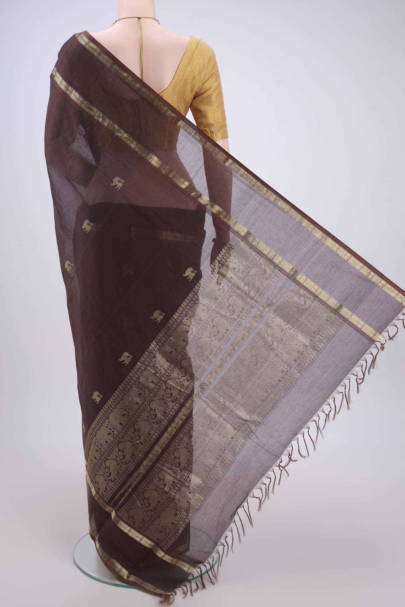 Flat view of Brown Kanchi Cotton Saree with Plain Body and Zari Border. 