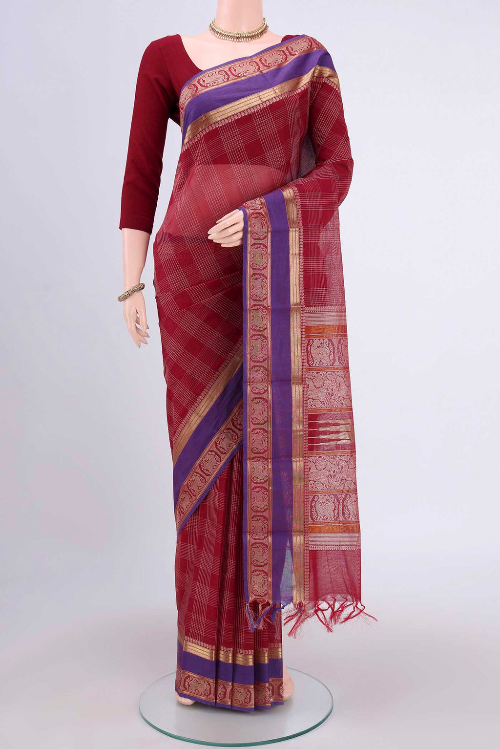 Red Kanchi Cotton Saree with Checked design on the body and Zari Border.  displayed on a mannequin
