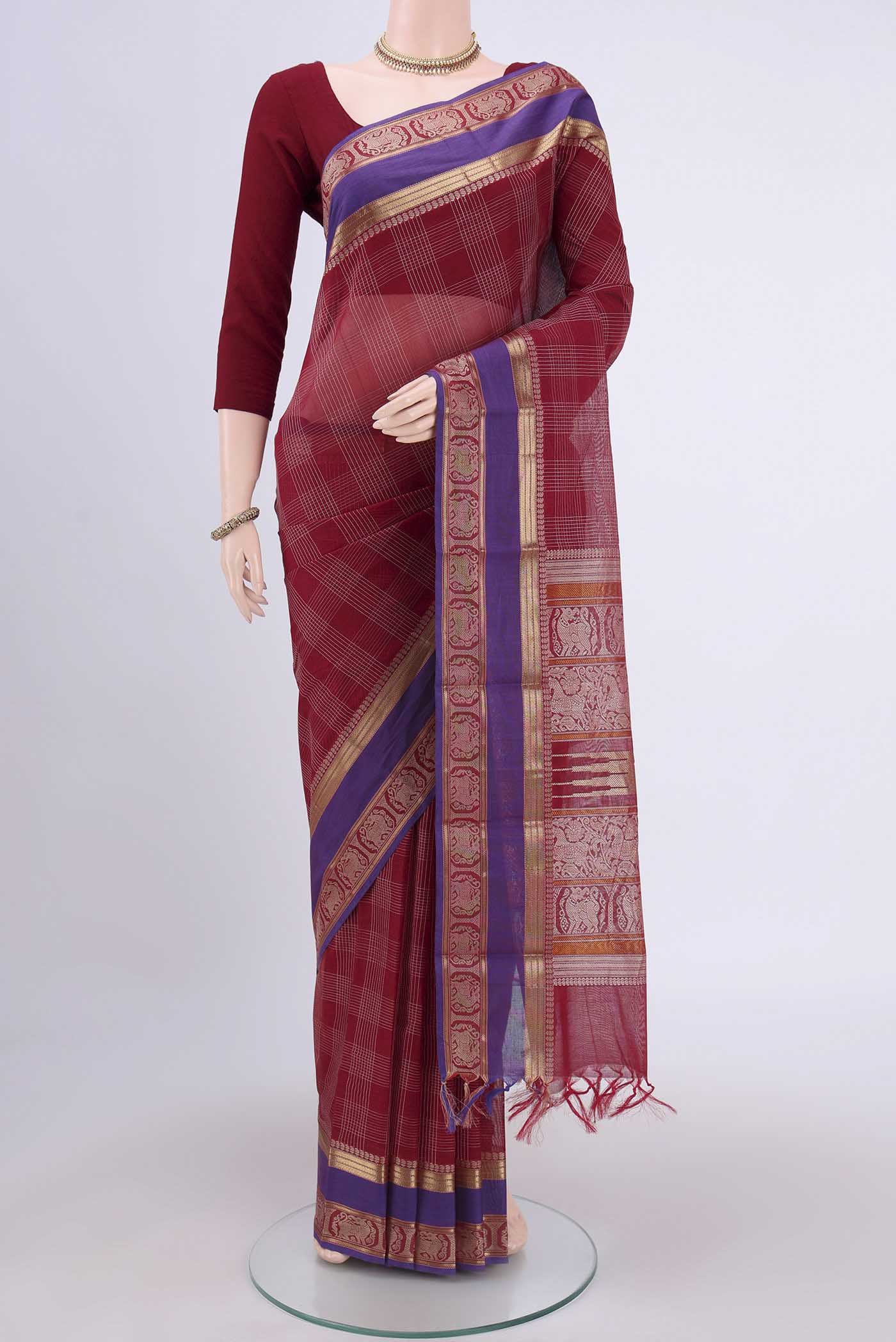 Red Kanchi Cotton Saree with Checked design on the body and Zari Border.  displayed on a mannequin
