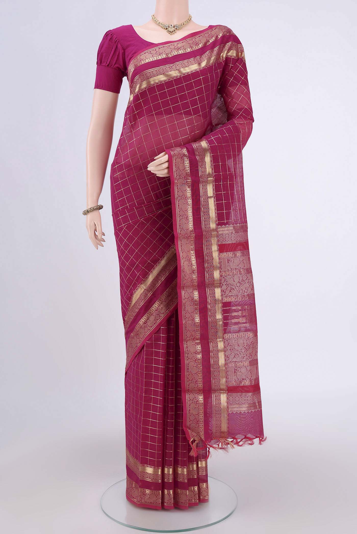 Rani Pink Kanchi Cotton Saree with Checked design on the body and Zari Border.  displayed on a mannequin