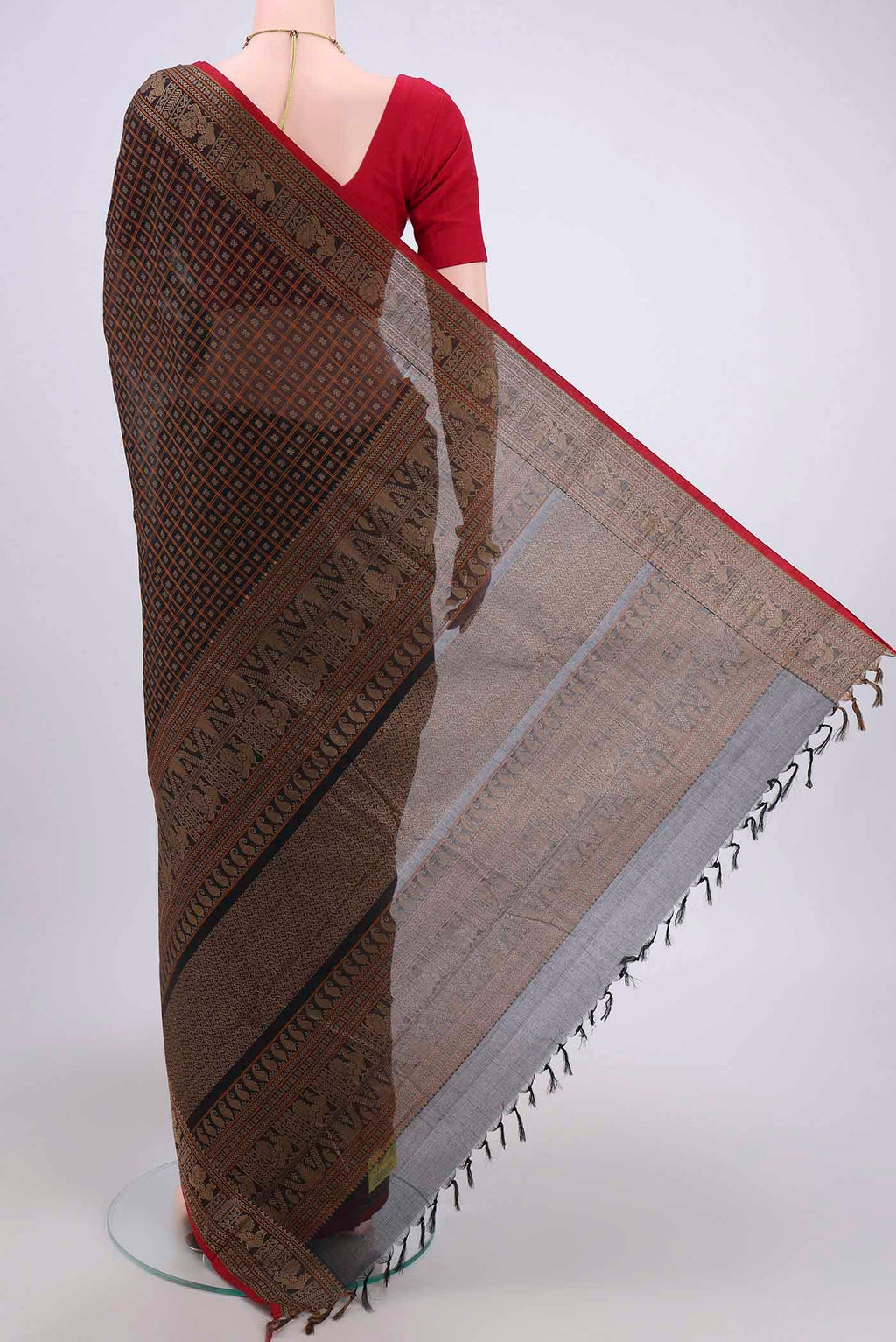 Flat view of Black Kanchi Cotton Saree with Checked design on the body and Zari Border. 
