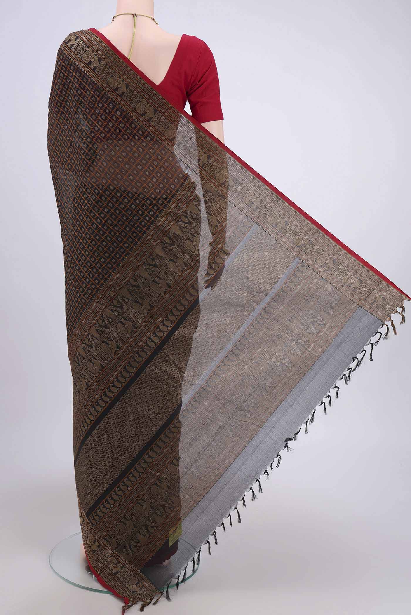 Flat view of Black Kanchi Cotton Saree with Checked design on the body and Zari Border. 