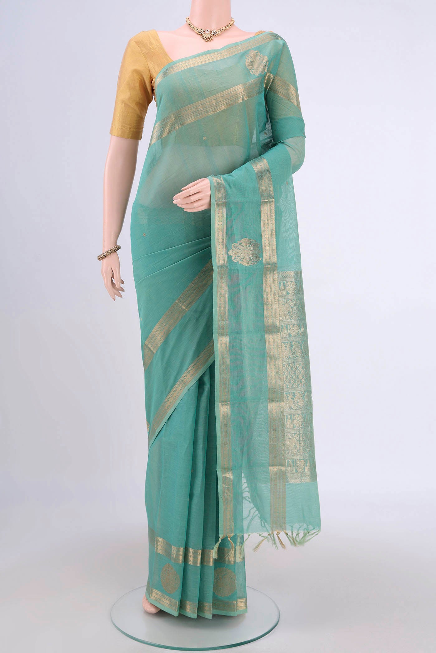 Turquoise Kanchi Cotton Saree with Zari Butta on the body and Zari Border.  displayed on a mannequin