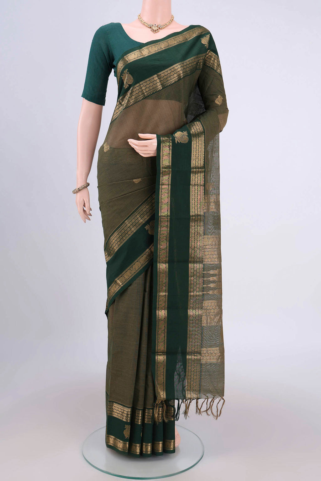 Mehandi Green Kanchi Cotton Saree with Plain Body and Zari Border.  displayed on a mannequin