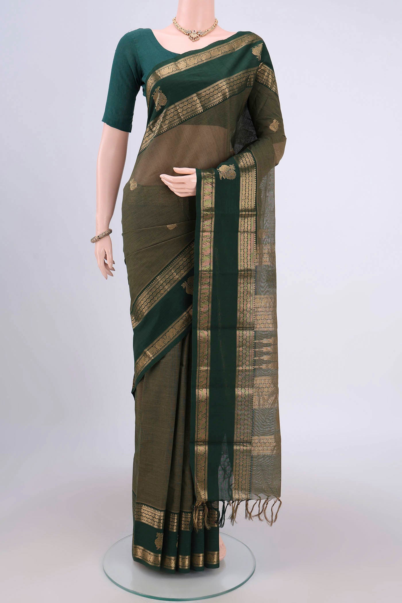 Mehandi Green Kanchi Cotton Saree with Plain Body and Zari Border.  displayed on a mannequin