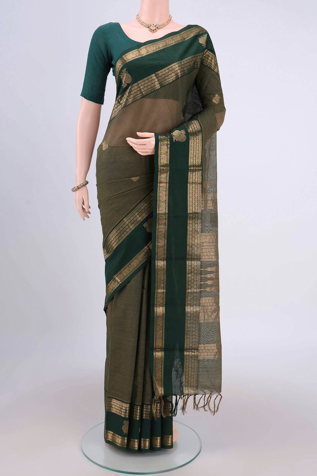 Mehandi Green Kanchi Cotton Saree with Plain Body and Zari Border.  displayed on a mannequin
