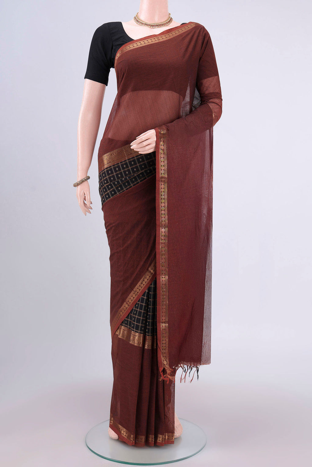 Black Kanchi Cotton Saree with Checked design on the body and Zari Border.  displayed on a mannequin