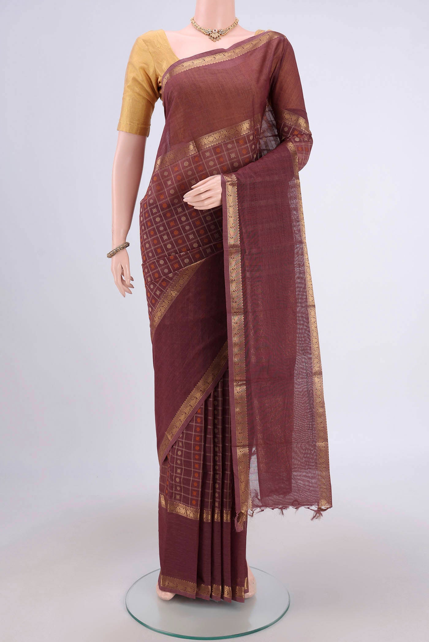 Coffee Brown Kanchi Cotton Saree with Checked design on the body and Zari Border.  displayed on a mannequin