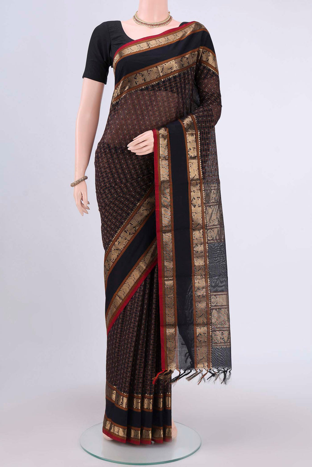 Black Kanchi Cotton Saree with Checked design on the body and Zari Border.  displayed on a mannequin