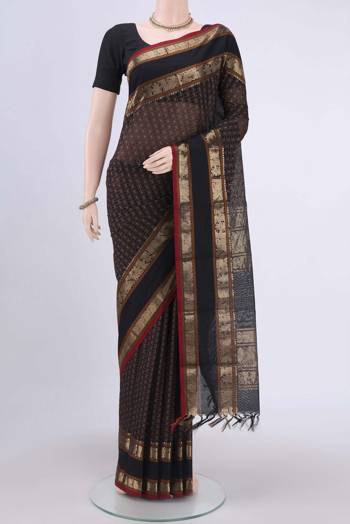 Black Kanchi Cotton Saree with Checked design on the body and Zari Border.  displayed on a mannequin