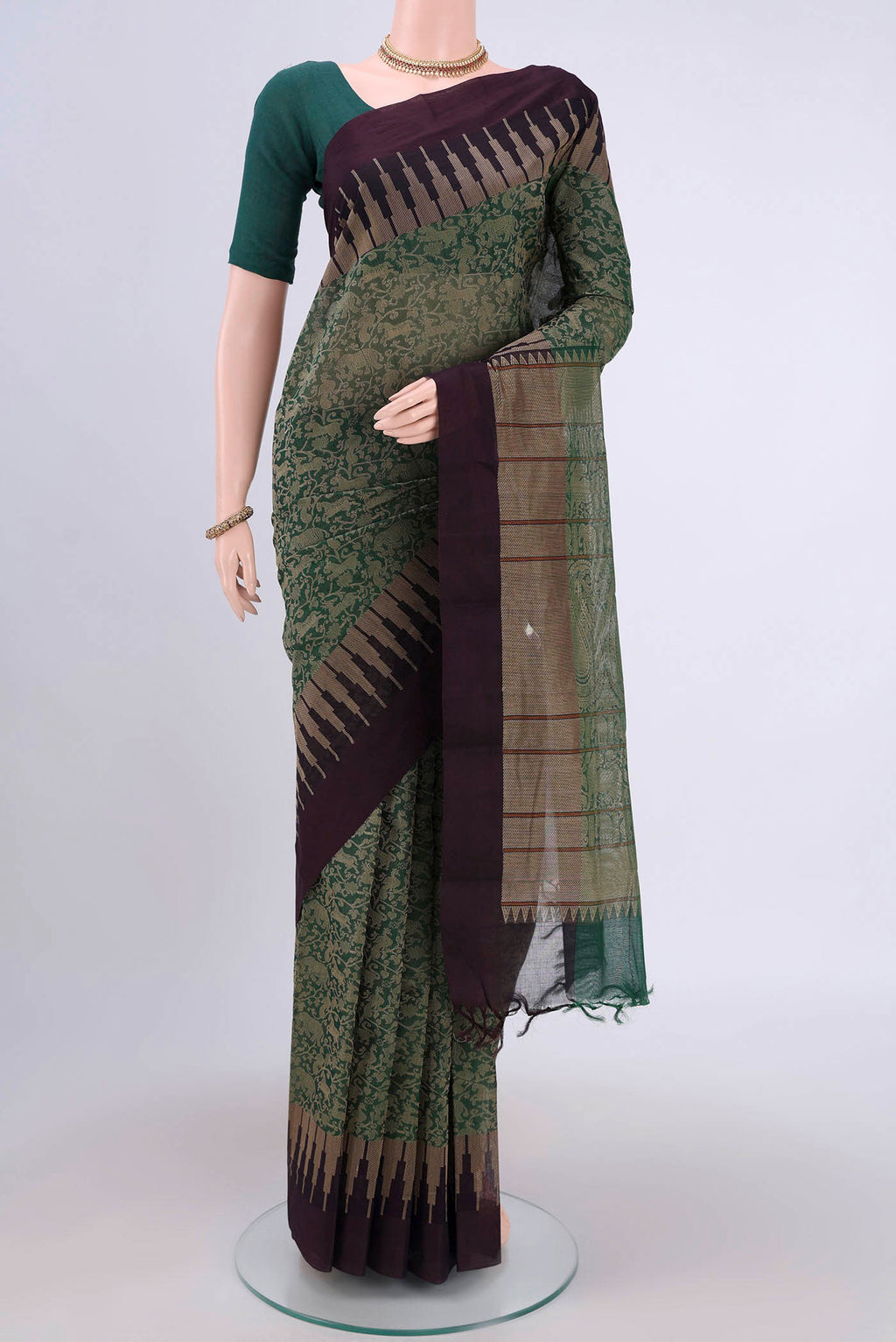 Green Kanchi Cotton Saree with Jacquard design on the body and Thread Border.  displayed on a mannequin