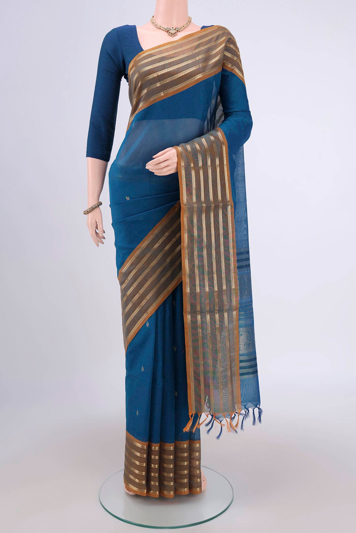 Blue Silk Cotton Saree with Zari Butta on the body and Zari Border.  displayed on a mannequin