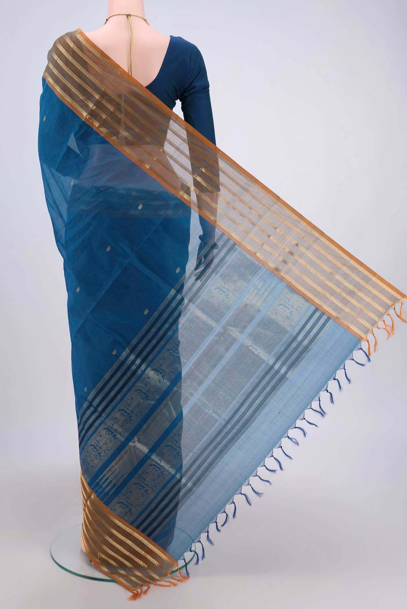 Flat view of Blue Silk Cotton Saree with Zari Butta on the body and Zari Border. 