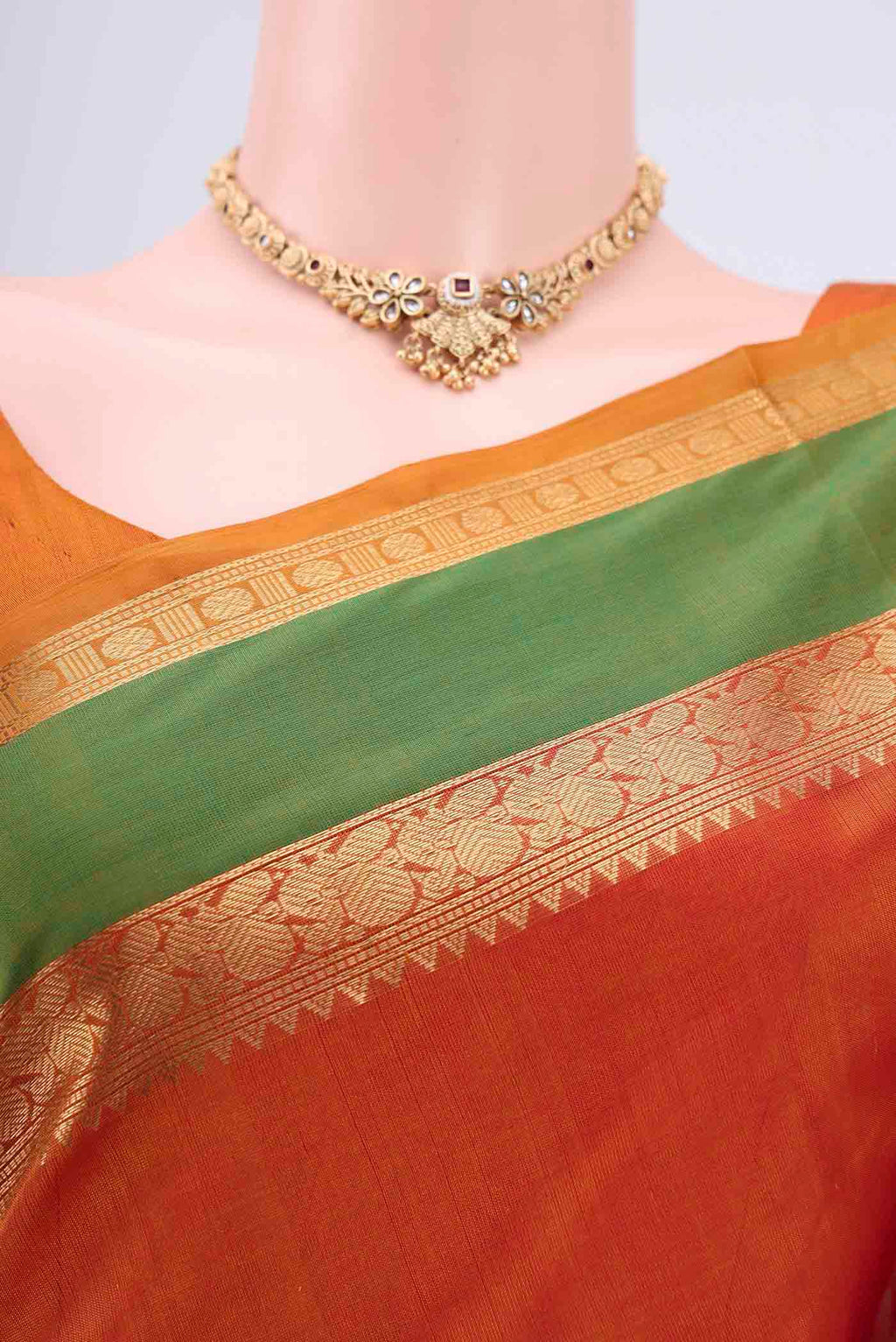 Border image of Rust Silk Cotton Saree with Zari Butta on the body and Zari Border. 