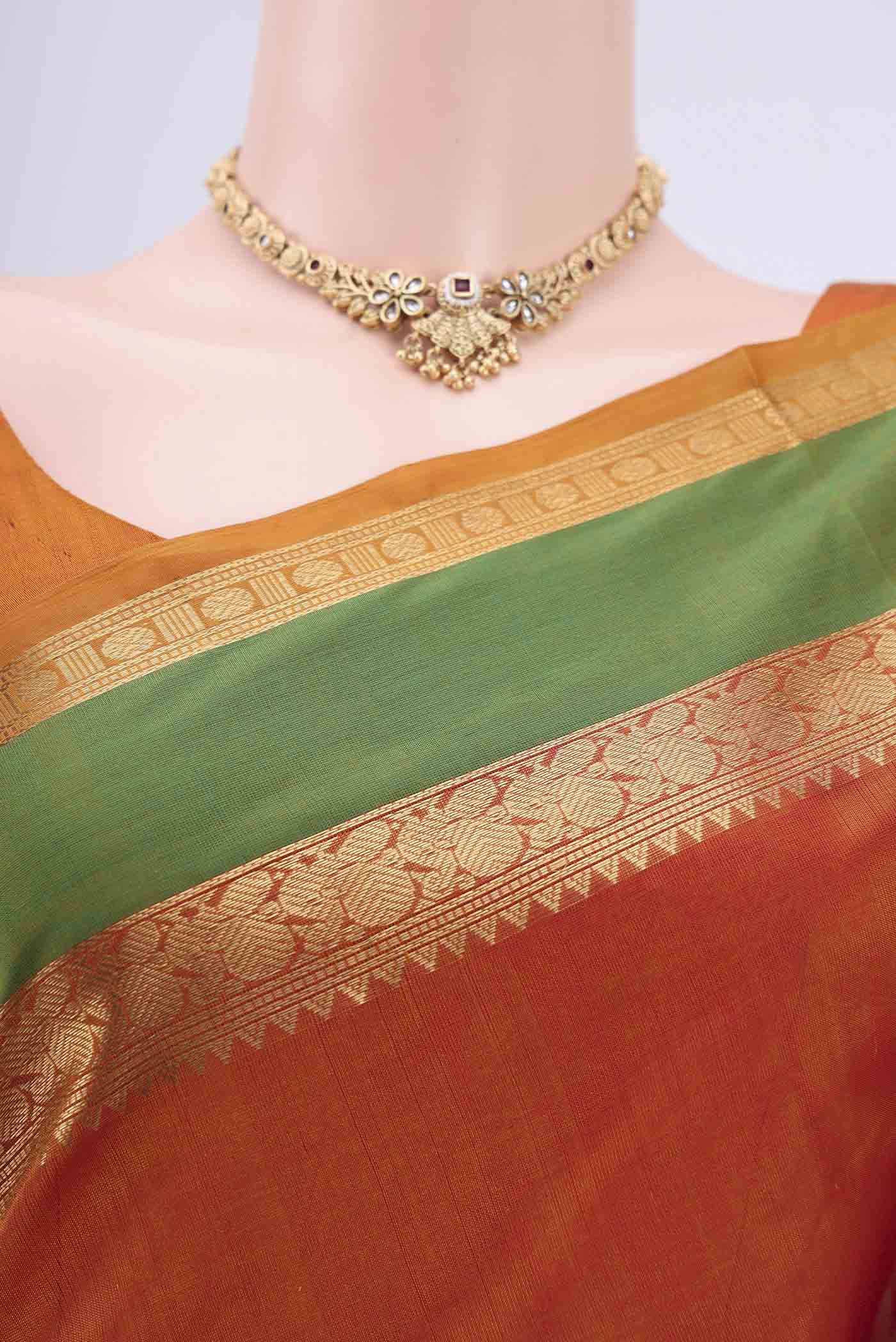Border image of Rust Silk Cotton Saree with Zari Butta on the body and Zari Border. 