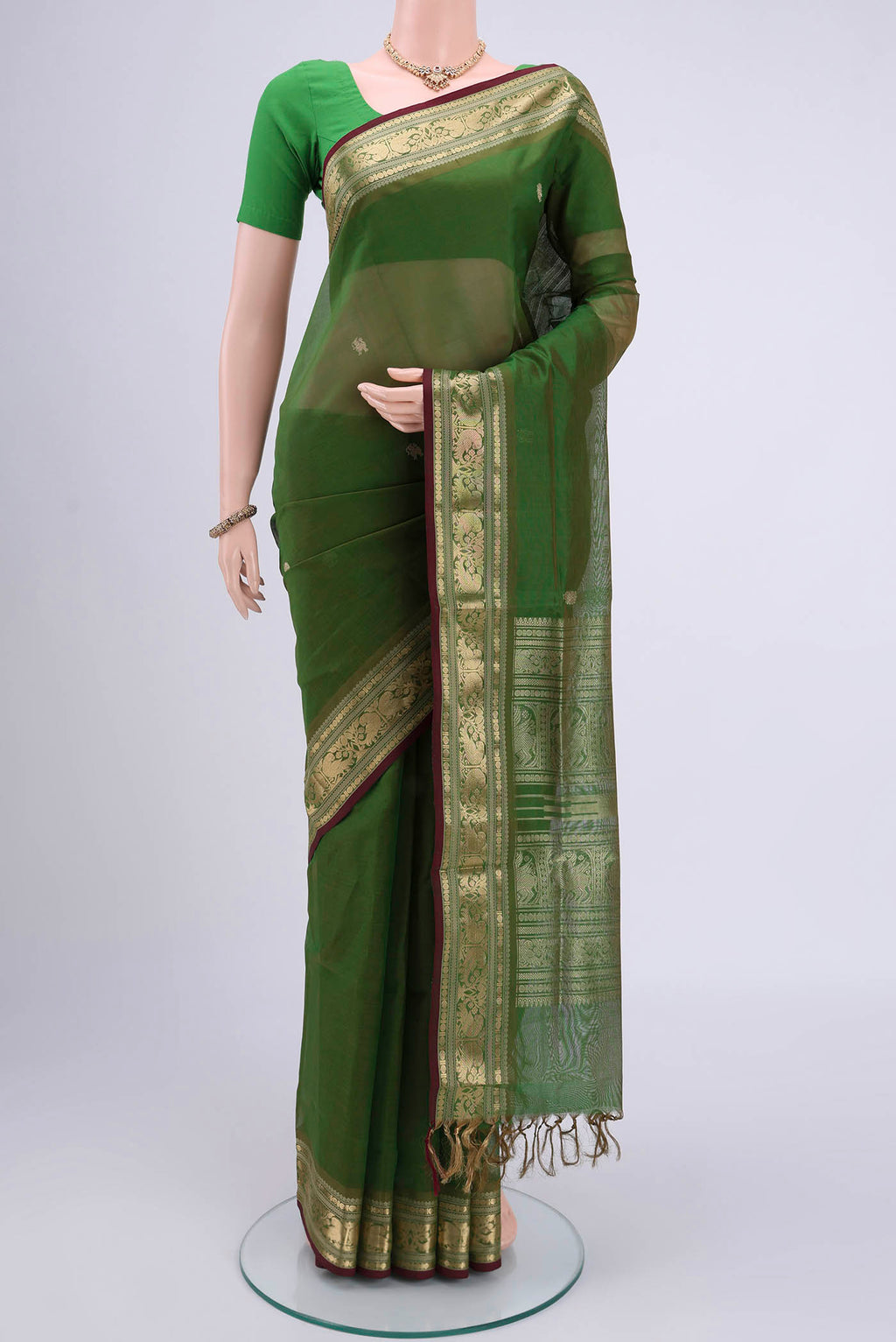 Light Green Blended Coimbatore Silk Cotton Saree with Zari Butta on the body and Zari Border.  displayed on a mannequin
