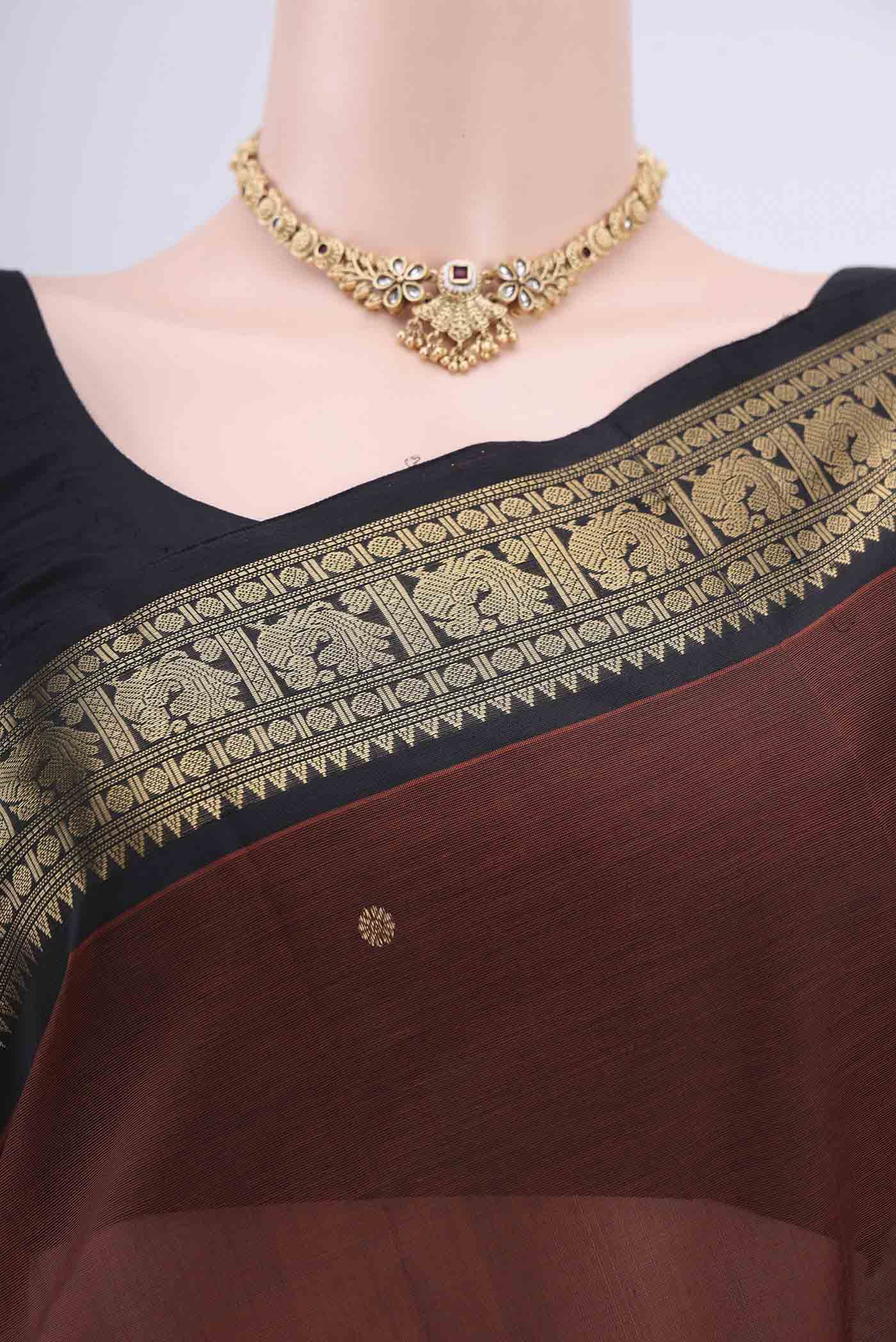 Border image of Brown Silk Cotton Saree with Zari Butta on the body and Zari Border. 