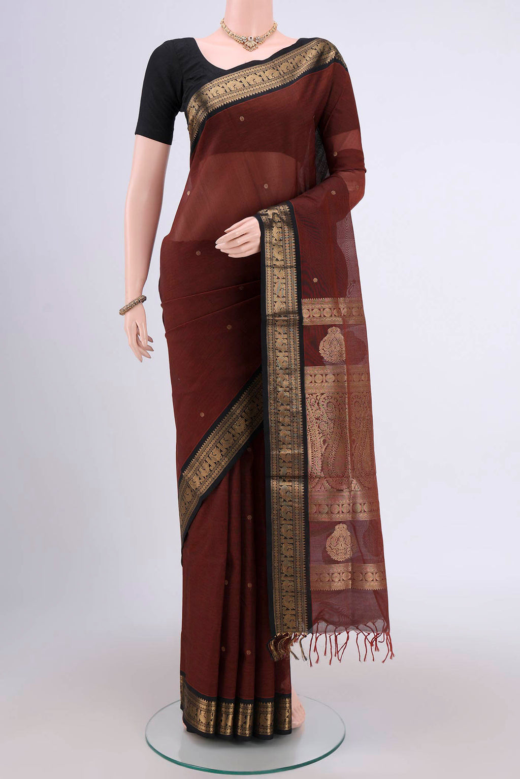 Brown Silk Cotton Saree with Zari Butta on the body and Zari Border.  displayed on a mannequin