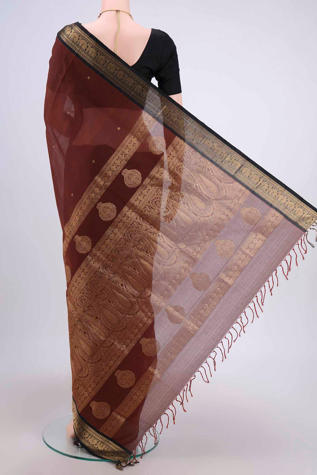 Flat view of Brown Silk Cotton Saree with Zari Butta on the body and Zari Border. 
