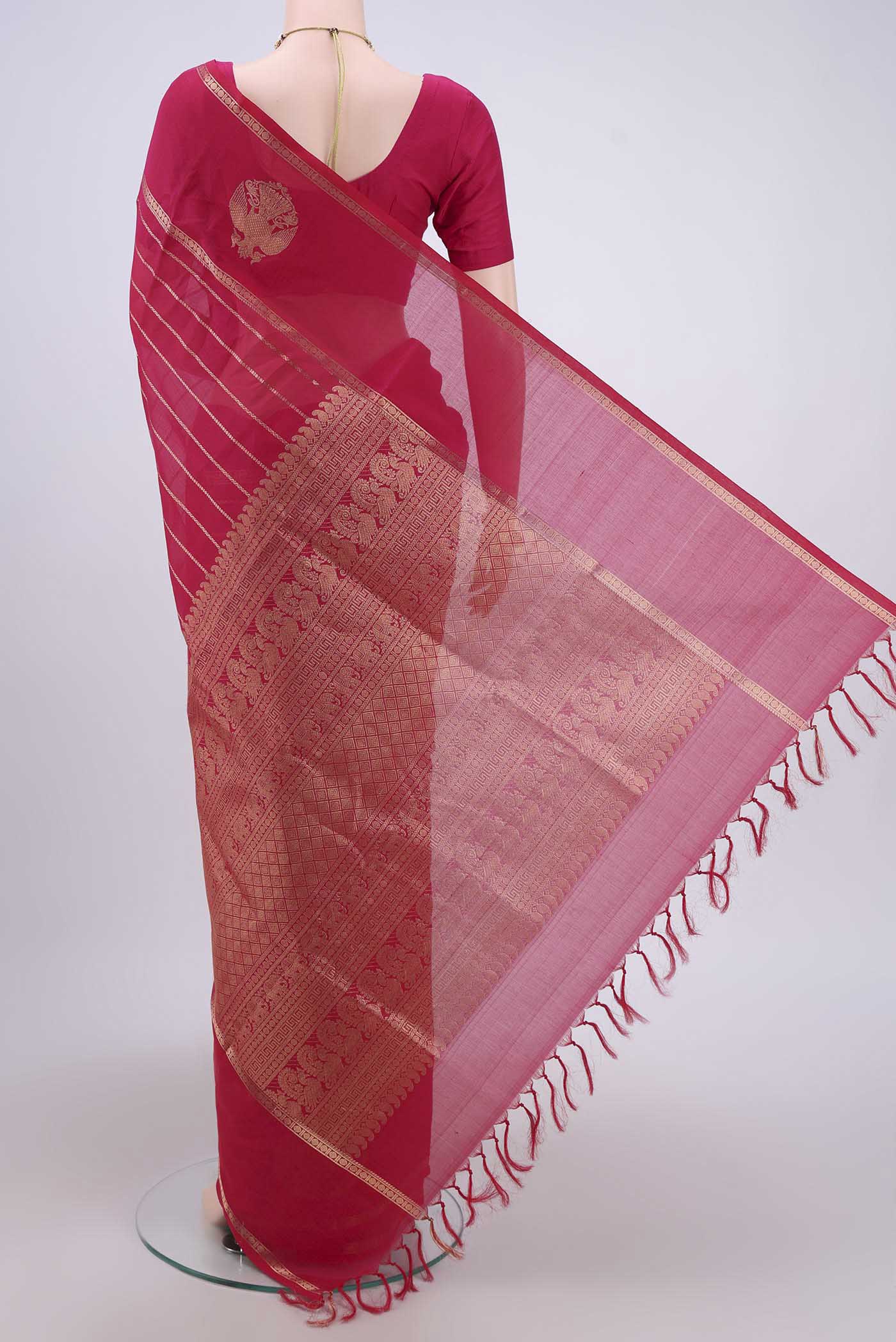 Flat view of Rani Pink Silk Cotton Saree with Veldhari on the body and Zari Border. 