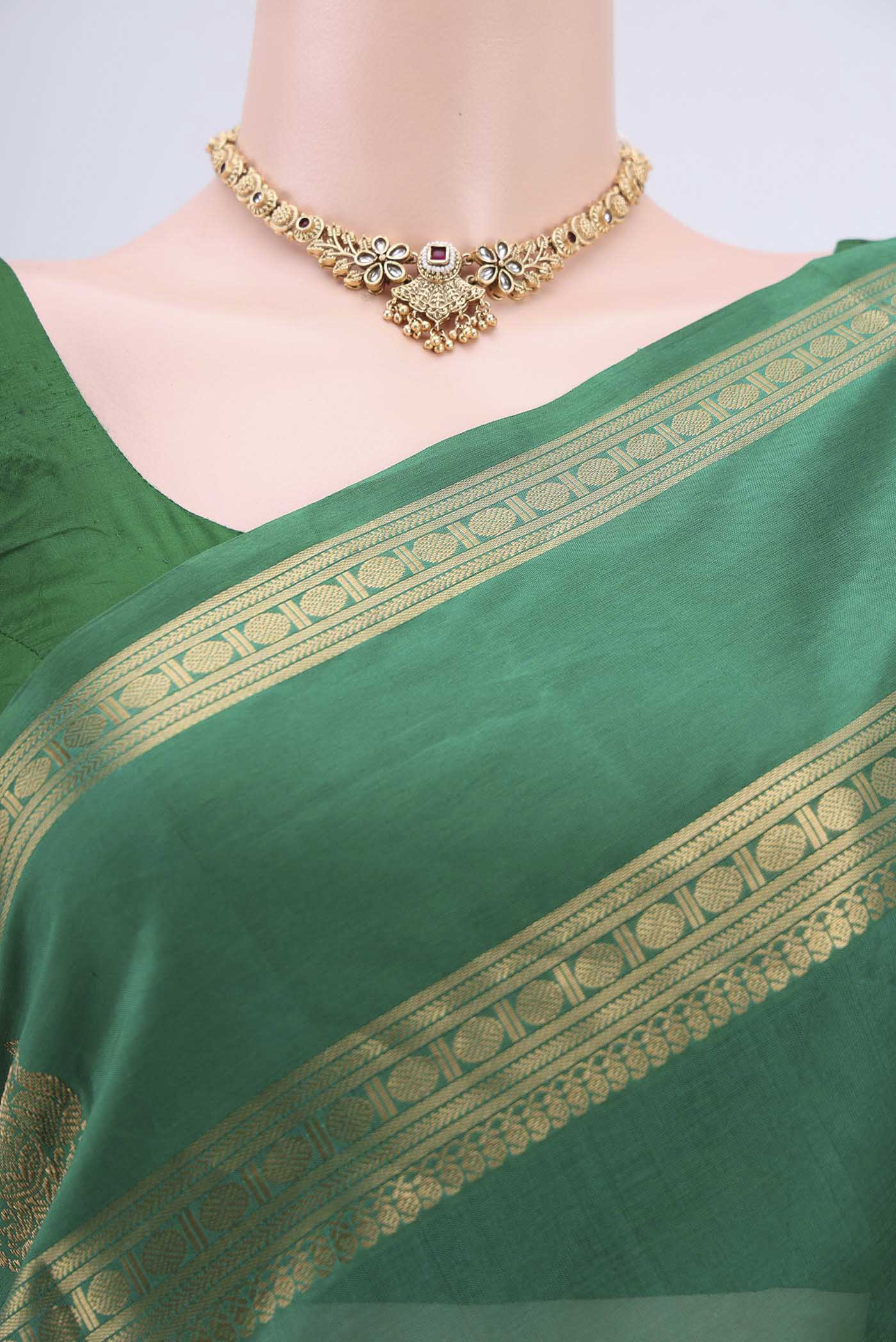 Border image of Green Silk Cotton Saree with Zari Butta on the body and Zari Border. 