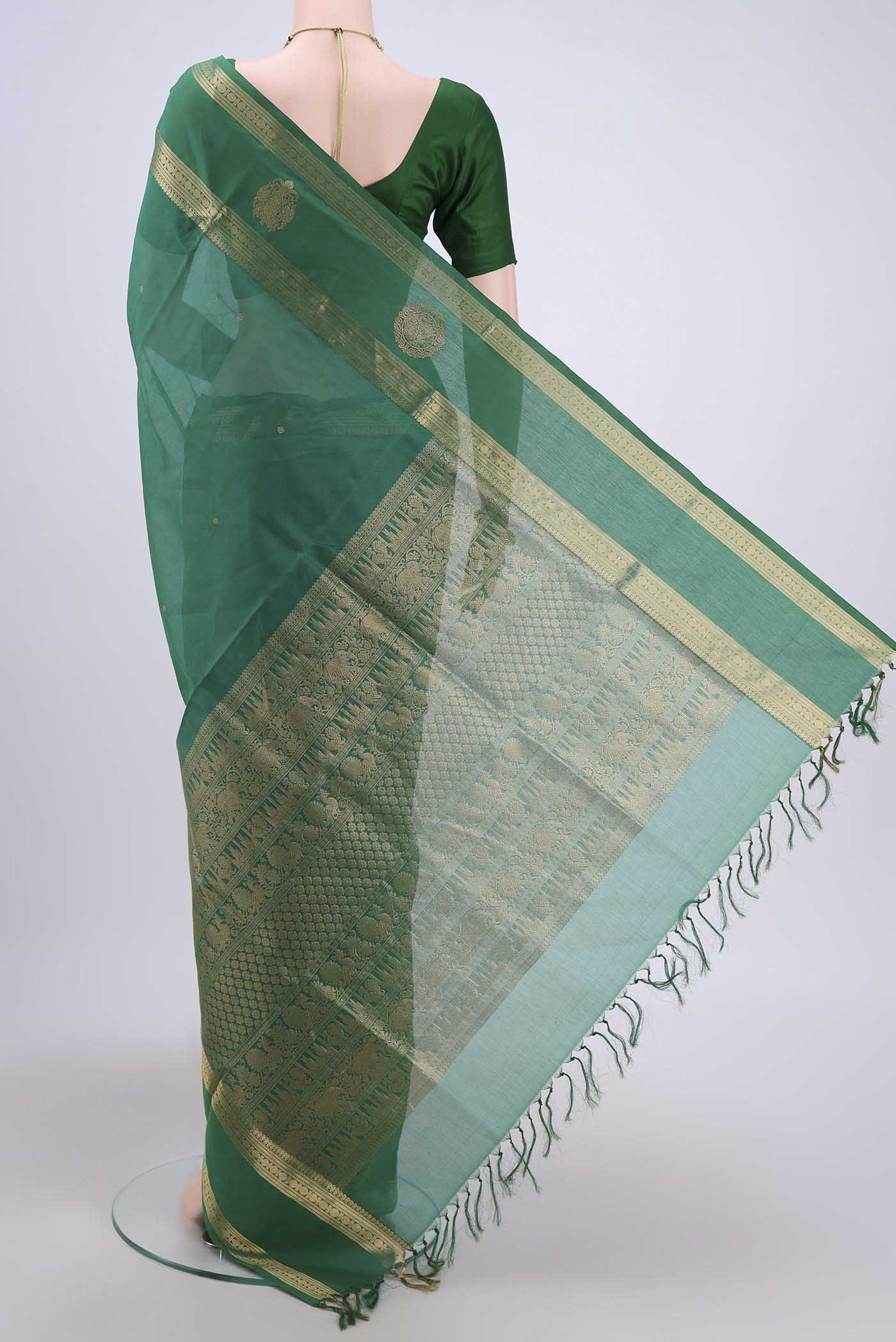 Flat view of Green Silk Cotton Saree with Zari Butta on the body and Zari Border. 