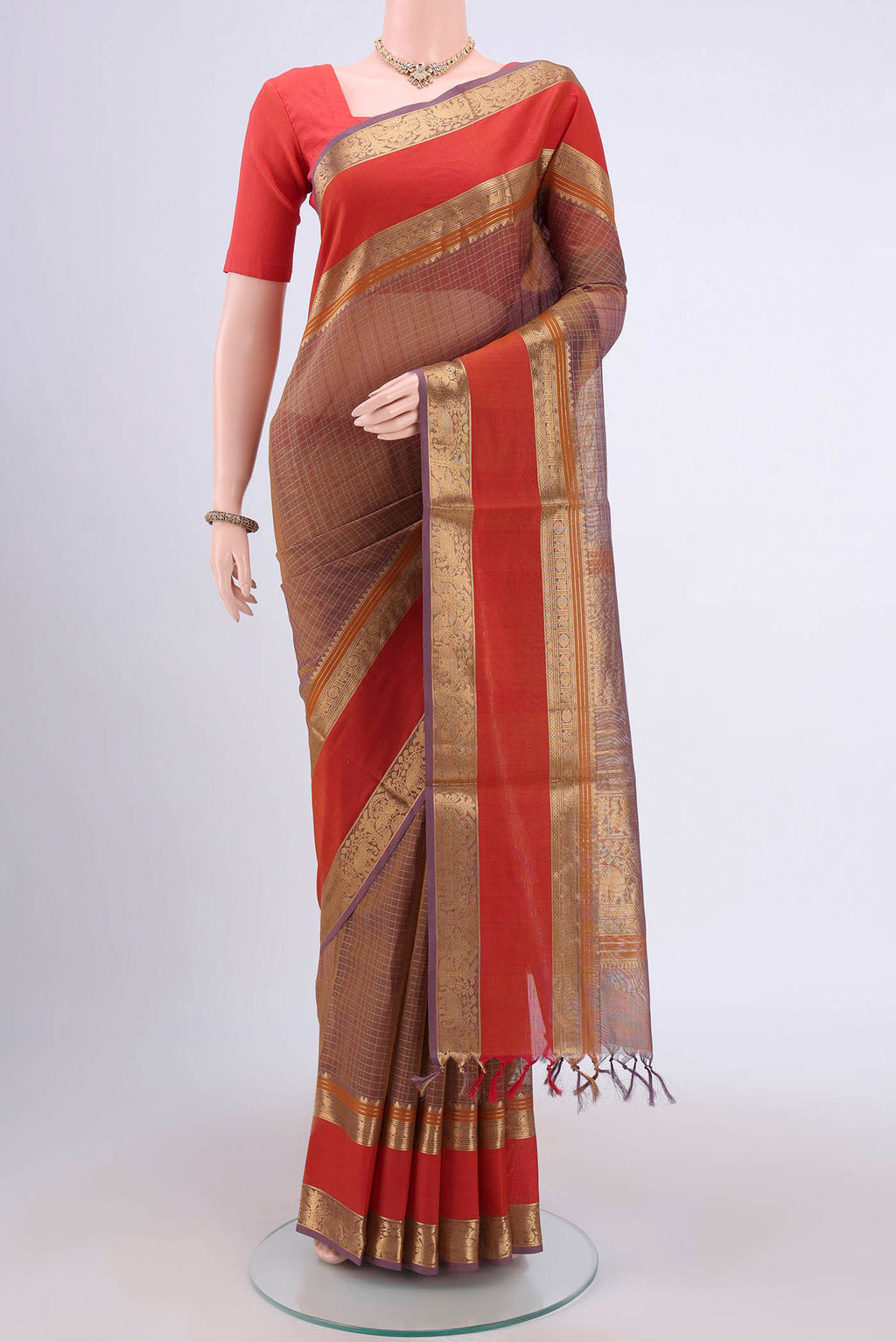 Brown Dual Tone Silk Cotton Saree with Checked design on the body and Zari And Thread Border.  displayed on a mannequin