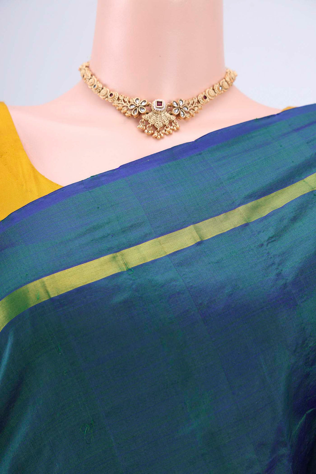 Border image of Peacock Blue Kanchipuram Saree with Plain Body and Zari And Thread Border. 