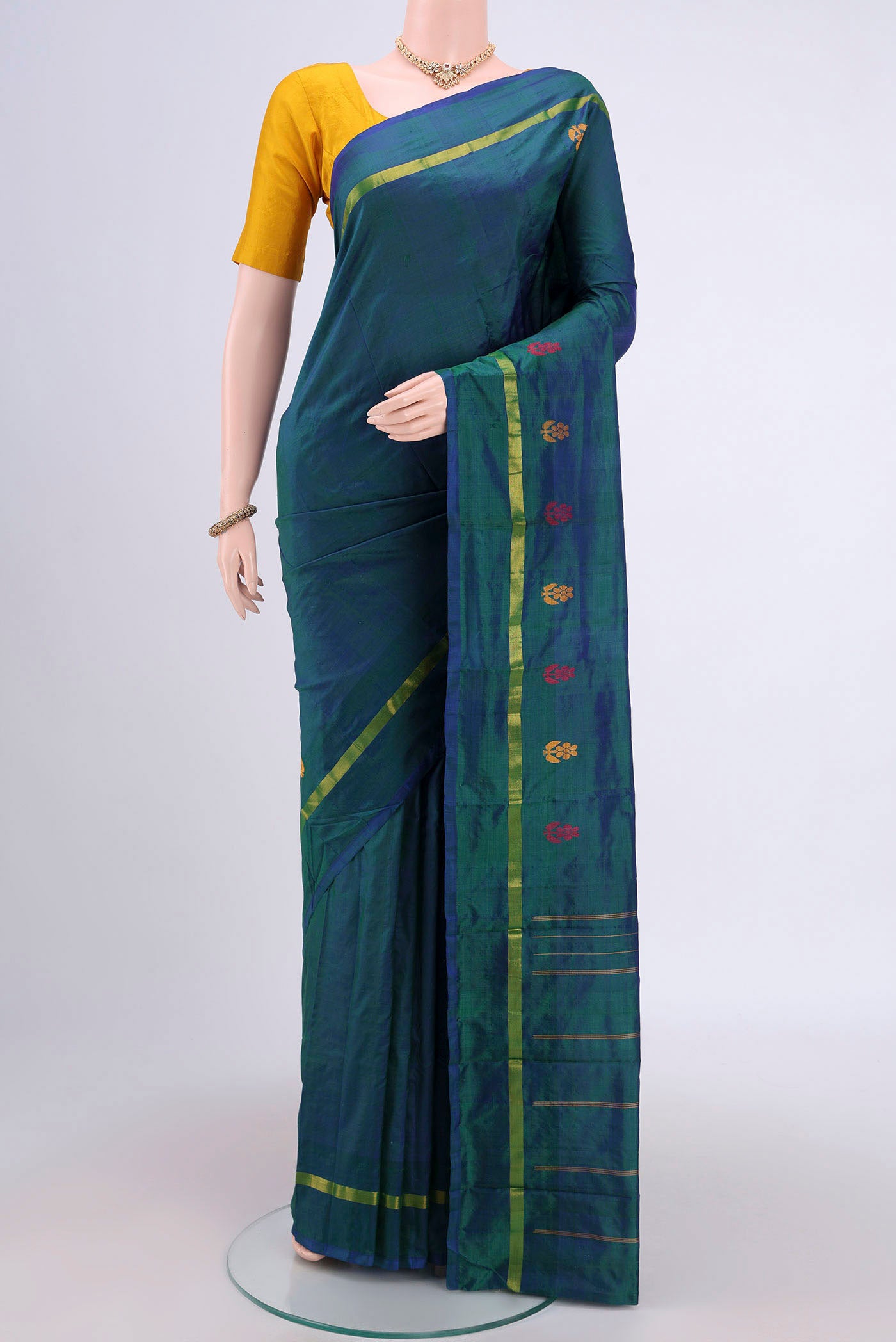 Peacock Blue Kanchipuram Saree with Plain Body and Zari And Thread Border.  displayed on a mannequin