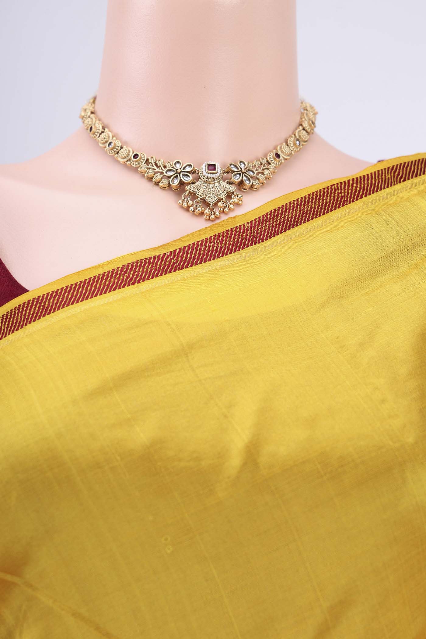 Border image of Yellow Kanchipuram Silk Saree with Plain Body and Zari And Thread Border. 
