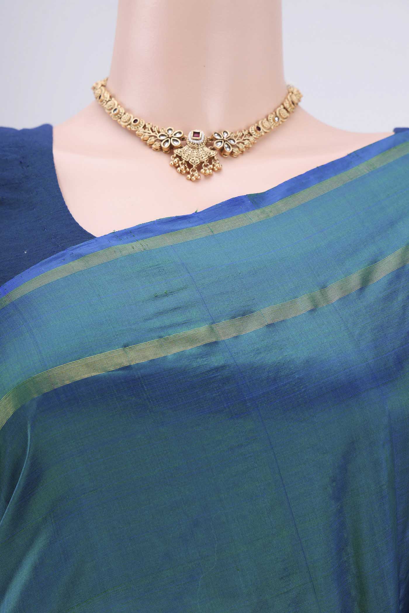 Border image of Peacock Blue Dual Tone Kanchipuram Silk Saree with Plain Body and Thread Border. 