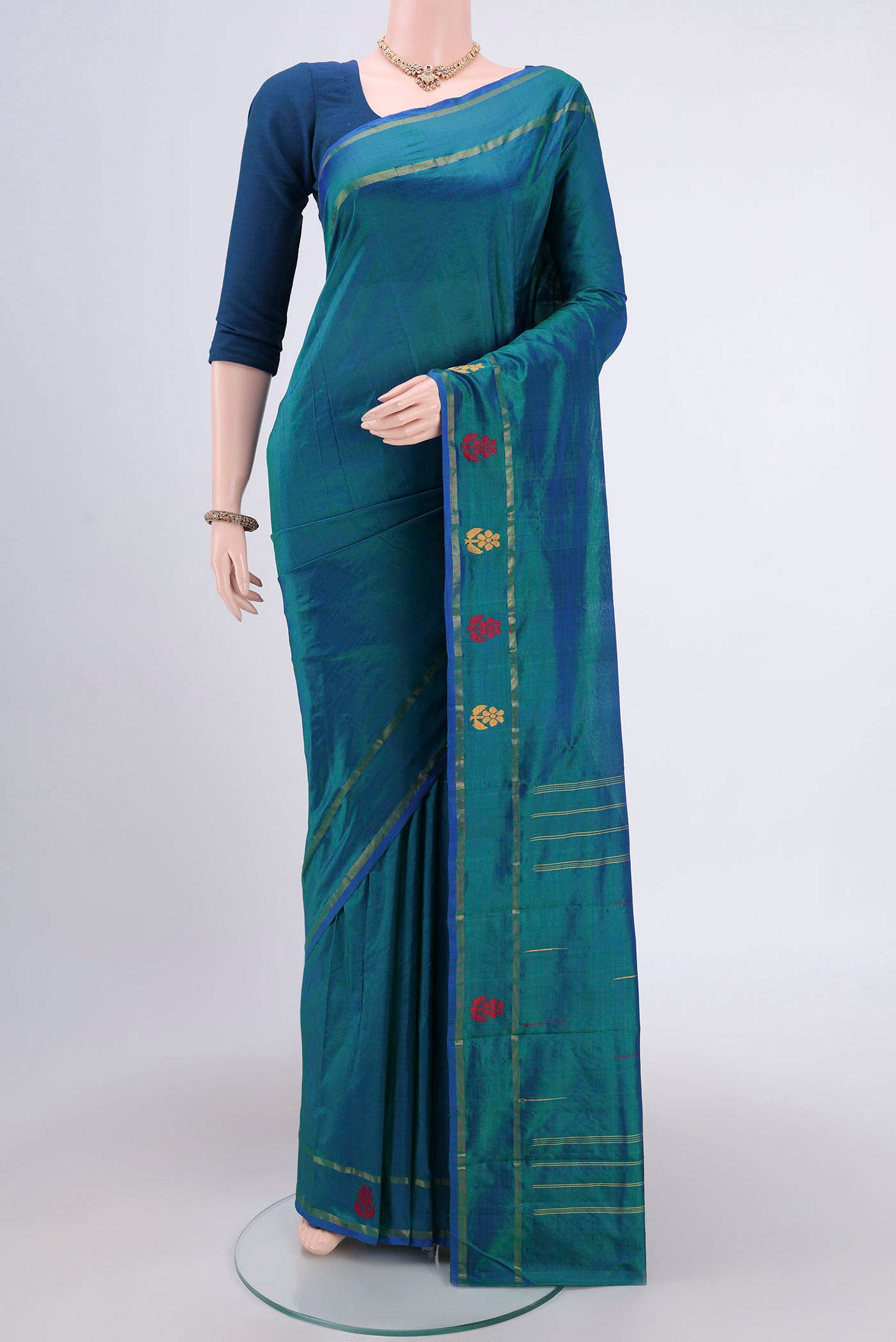 Peacock Blue Dual Tone Kanchipuram Silk Saree with Plain Body and Thread Border.  displayed on a mannequin